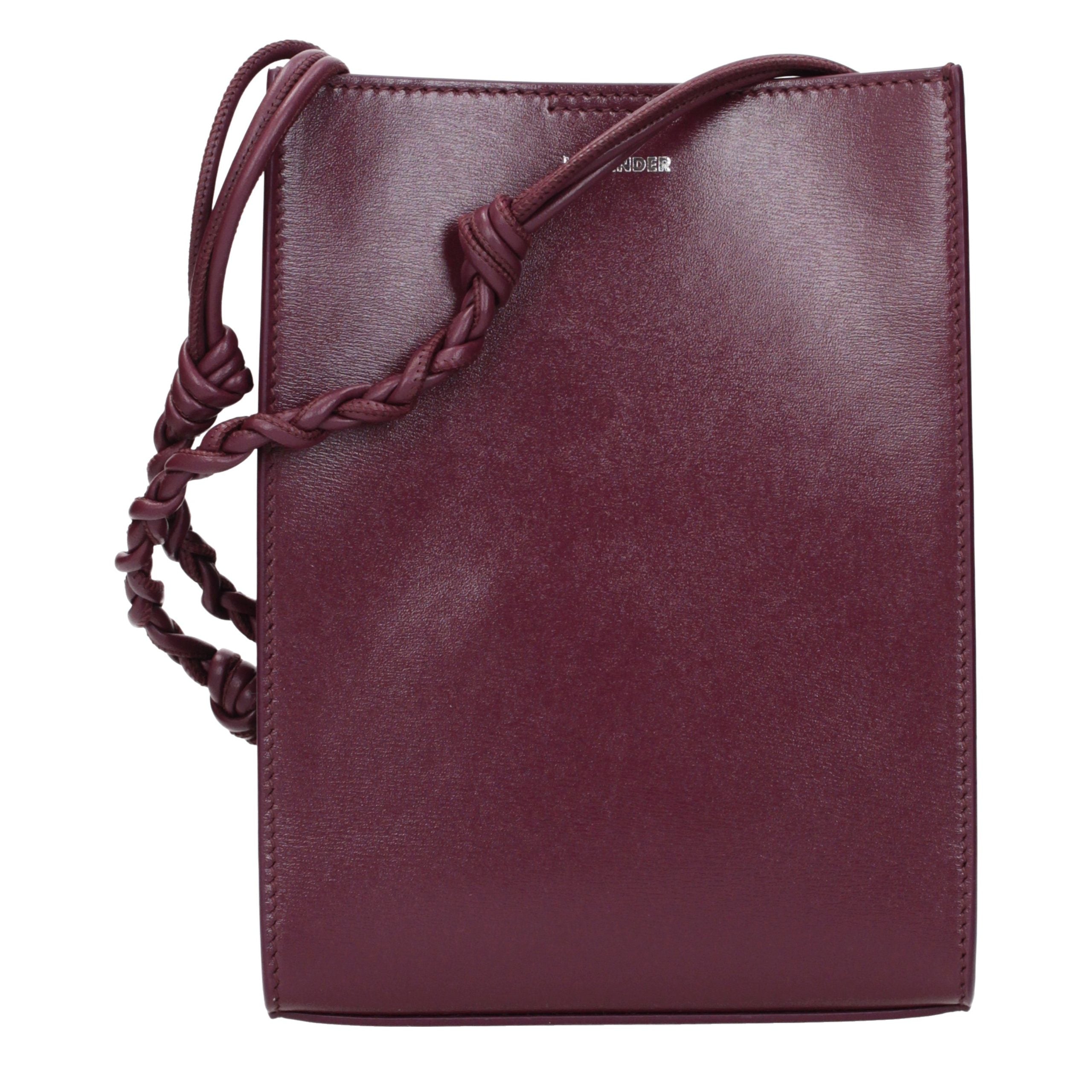 Discover the Jil Sander Purple Leather Crossbody Bag, a masterpiece of exquisite craftsmanship and modern elegance, perfect for the discerning individual who values luxury.