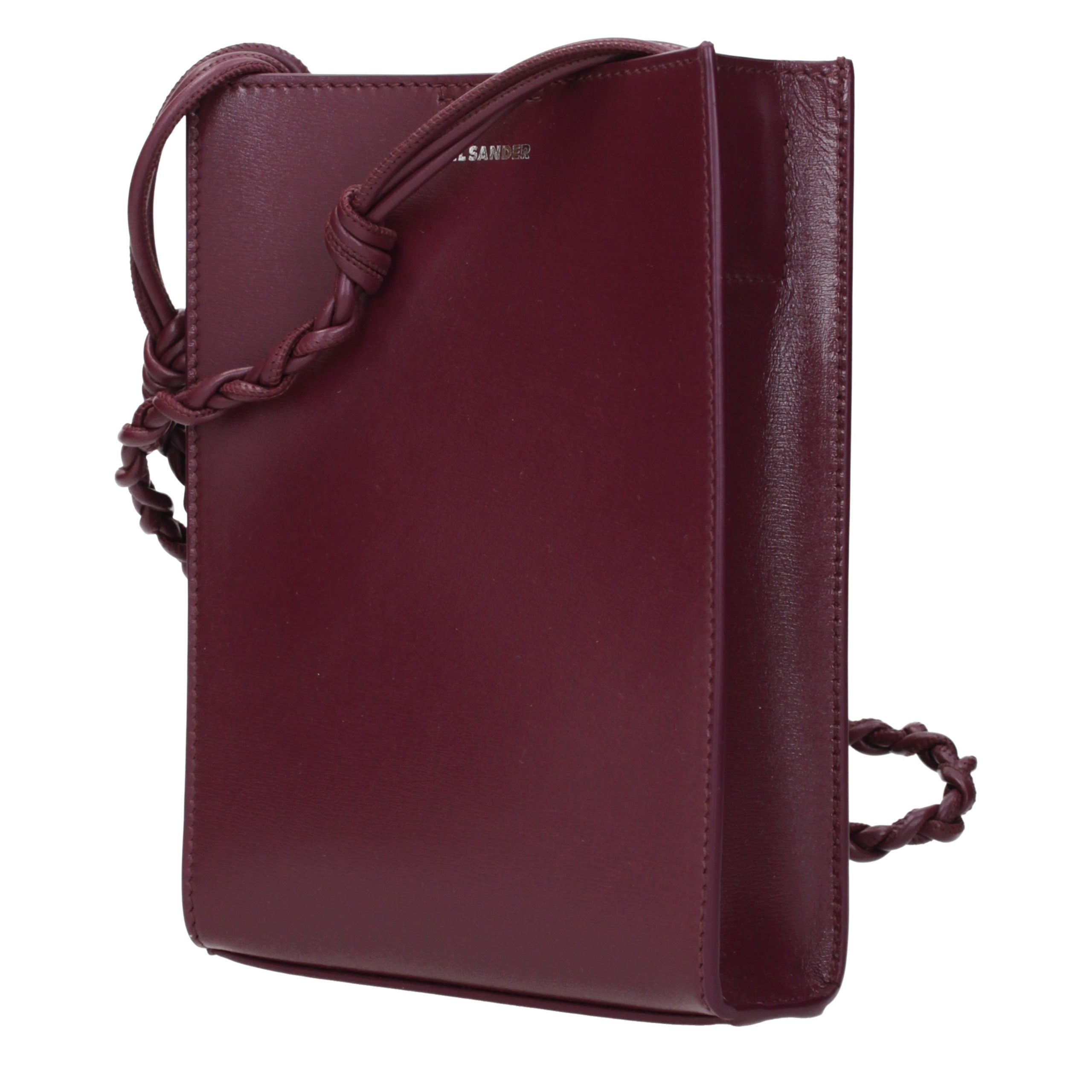Discover the Jil Sander Purple Leather Crossbody Bag, a masterpiece of exquisite craftsmanship and modern elegance, perfect for the discerning individual seeking timeless luxury.