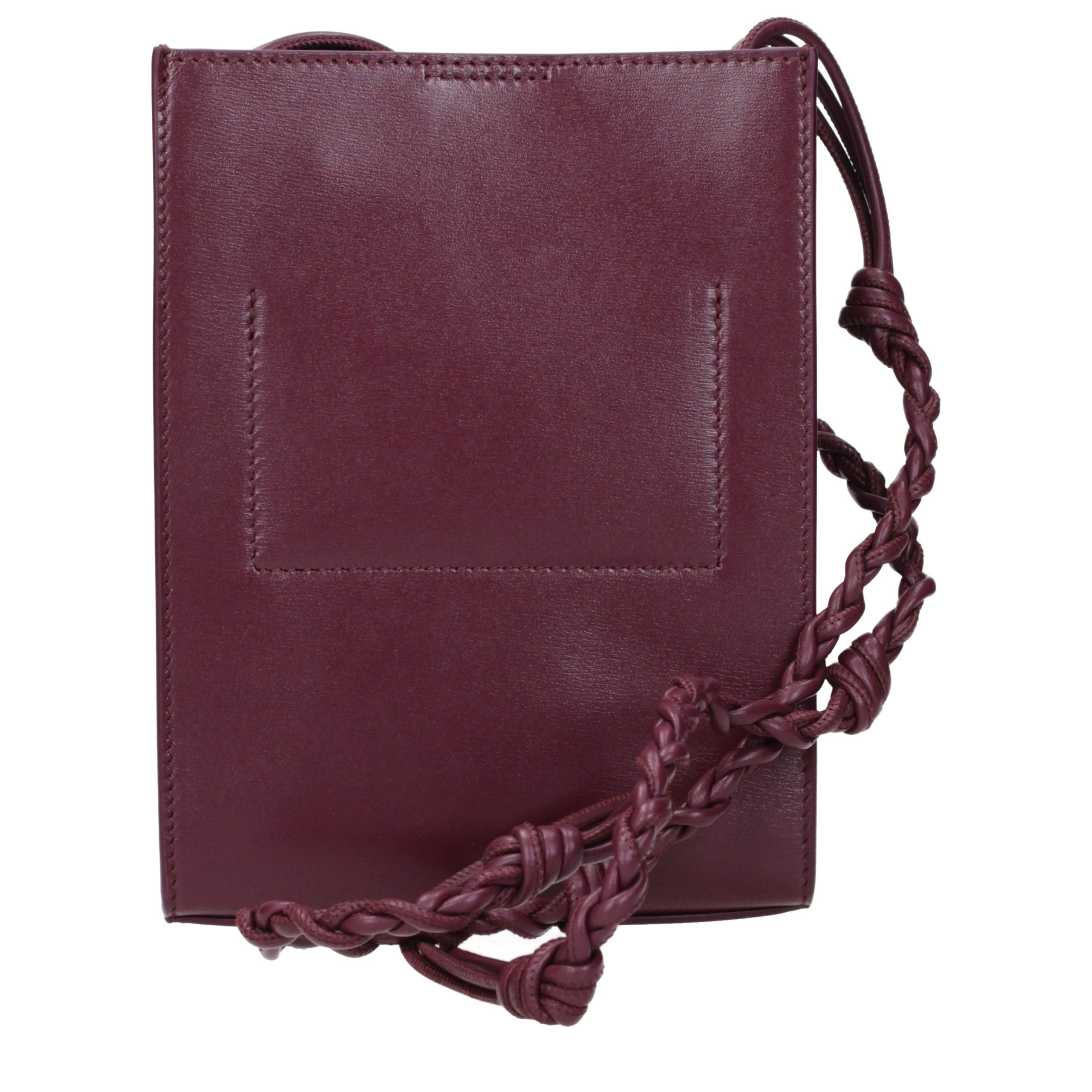 Discover the Jil Sander Purple Leather Crossbody Bag, a masterpiece of exquisite craftsmanship and modern elegance, perfect for the discerning individual who values luxury.