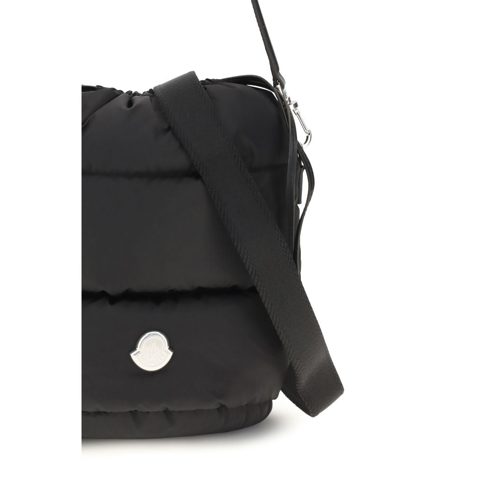 Indulge in the Moncler Caradoc Bucket Bag, a luxurious fusion of padded nylon and exquisite craftsmanship, embodying modern elegance for the discerning individual.