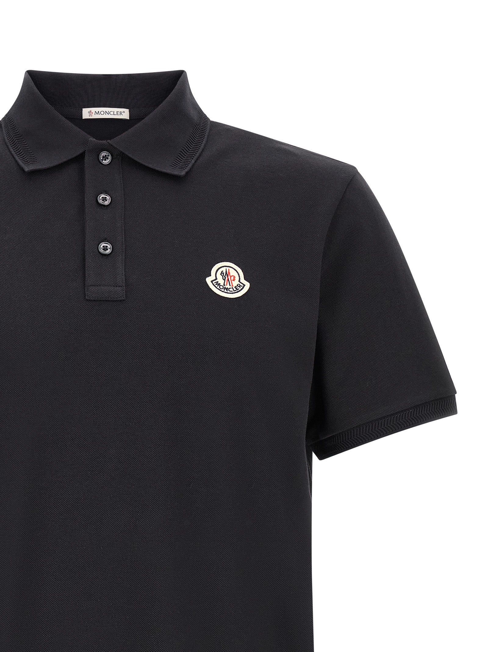 Experience the essence of sophistication with the Moncler Blue Cotton Polo Shirt, a timeless luxury crafted from premium cotton piquet, perfect for the discerning individual.