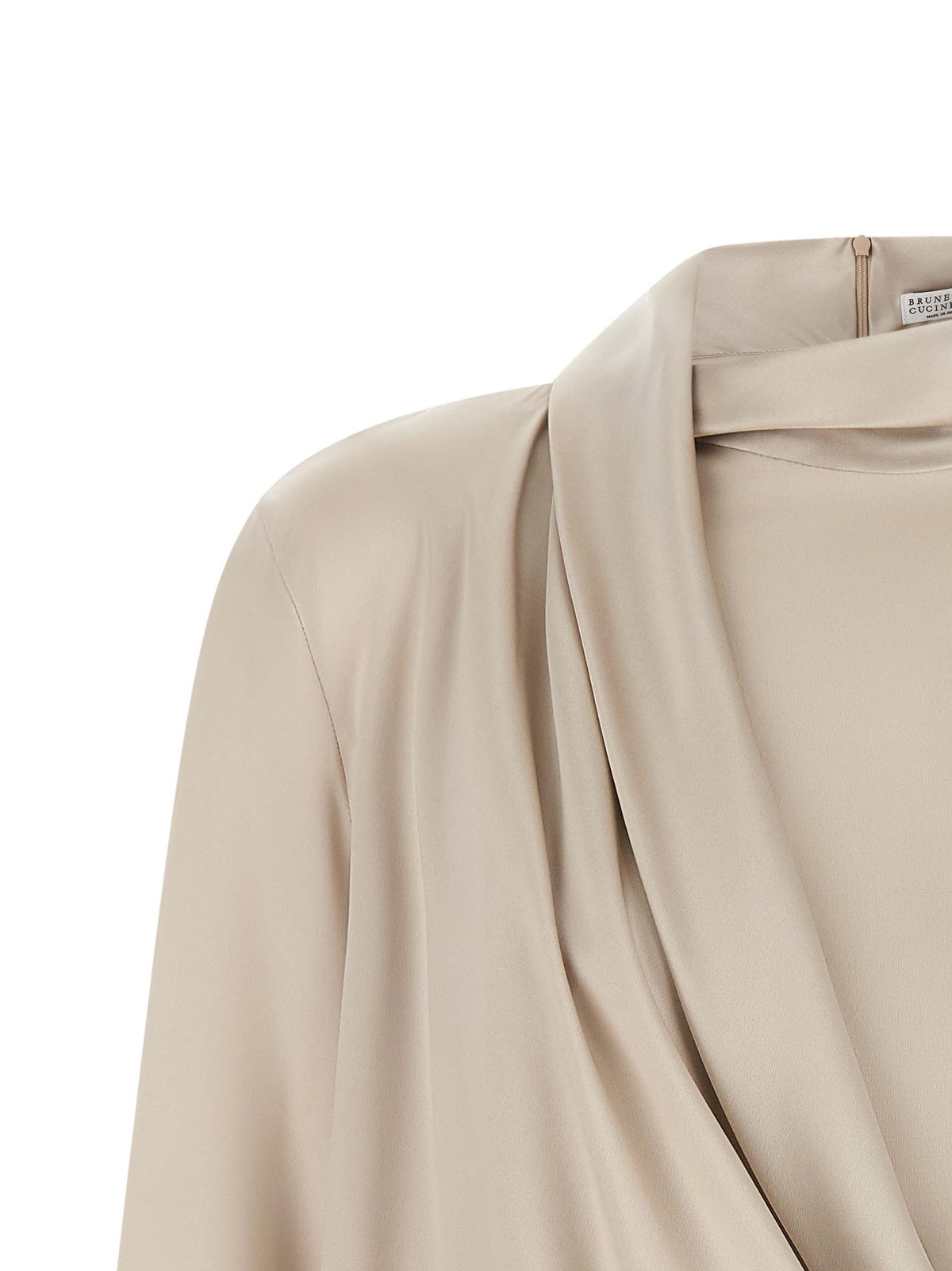 Indulge in the exquisite Brunello Cucinelli Beige Silk Blouse, a masterpiece of fluid stretch silk, embodying luxury and sophistication for the discerning individual.
