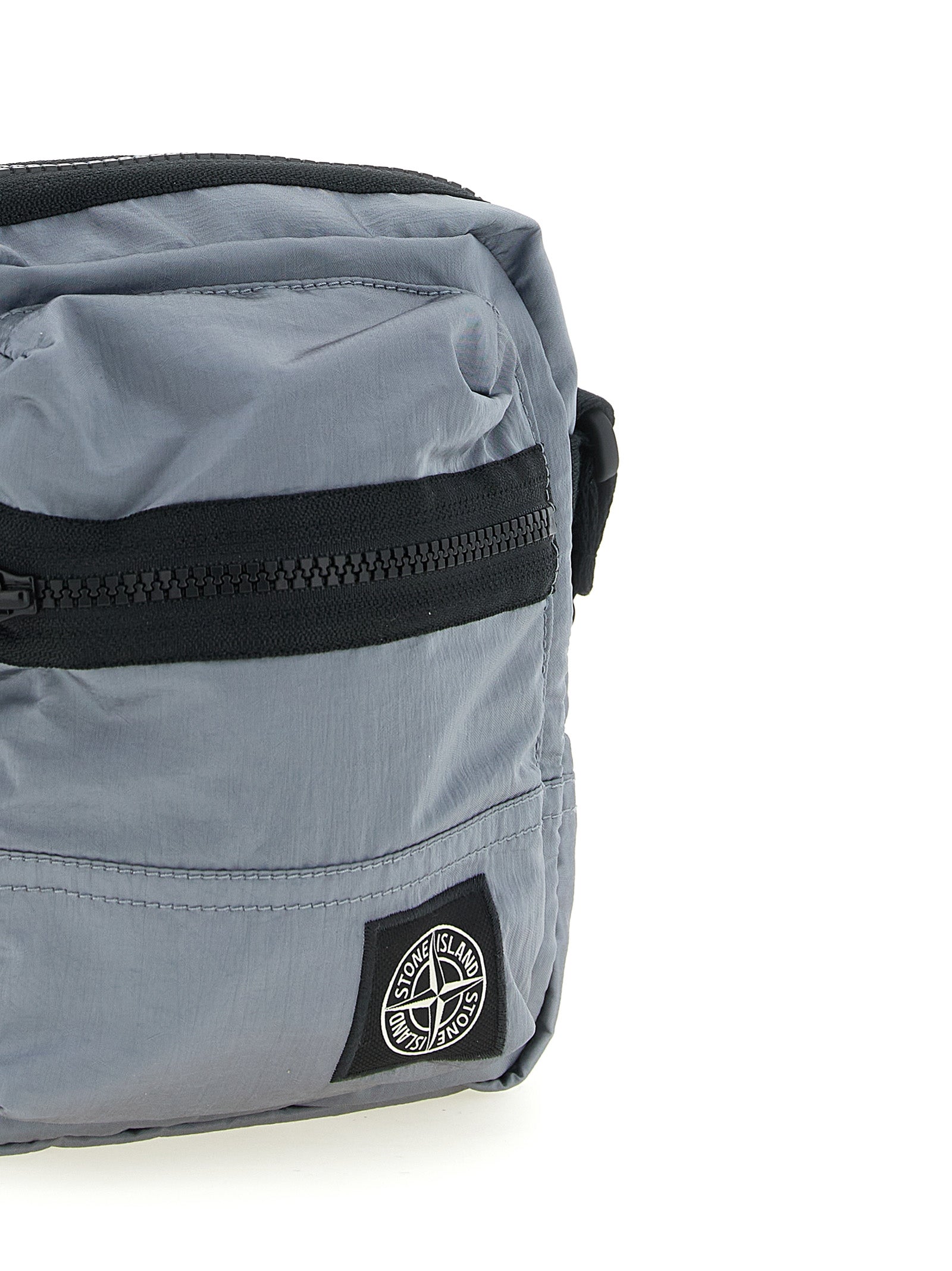 Discover the Stone Island Gray Polyamide Crossbody Bag, a fusion of sustainable luxury and urban elegance, crafted from iridescent ECONYL® nylon for the discerning individual.