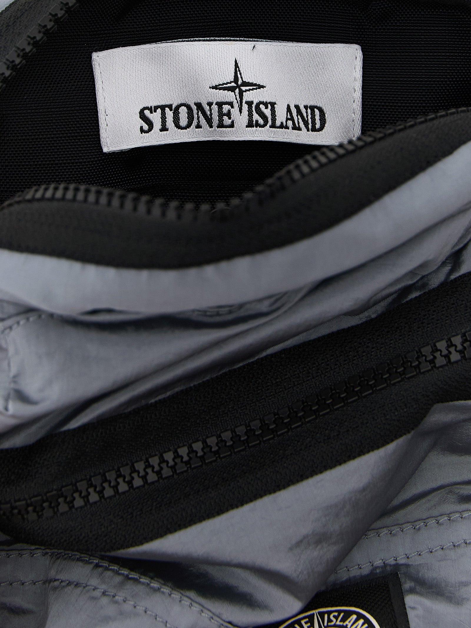 Discover the Stone Island Gray Polyamide Crossbody Bag, a fusion of iridescent luxury and sustainable elegance, perfect for those who command style and sophistication.