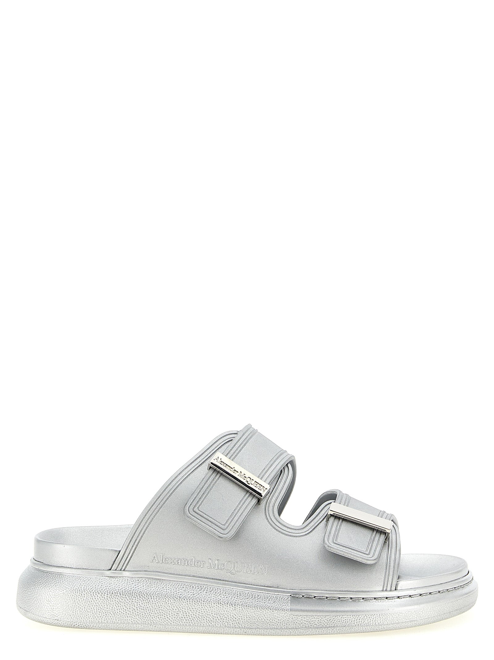 Experience the allure of Alexander McQueen's Silver Rubber Slides, where avant-garde design meets luxurious comfort, perfect for the discerning connoisseur.