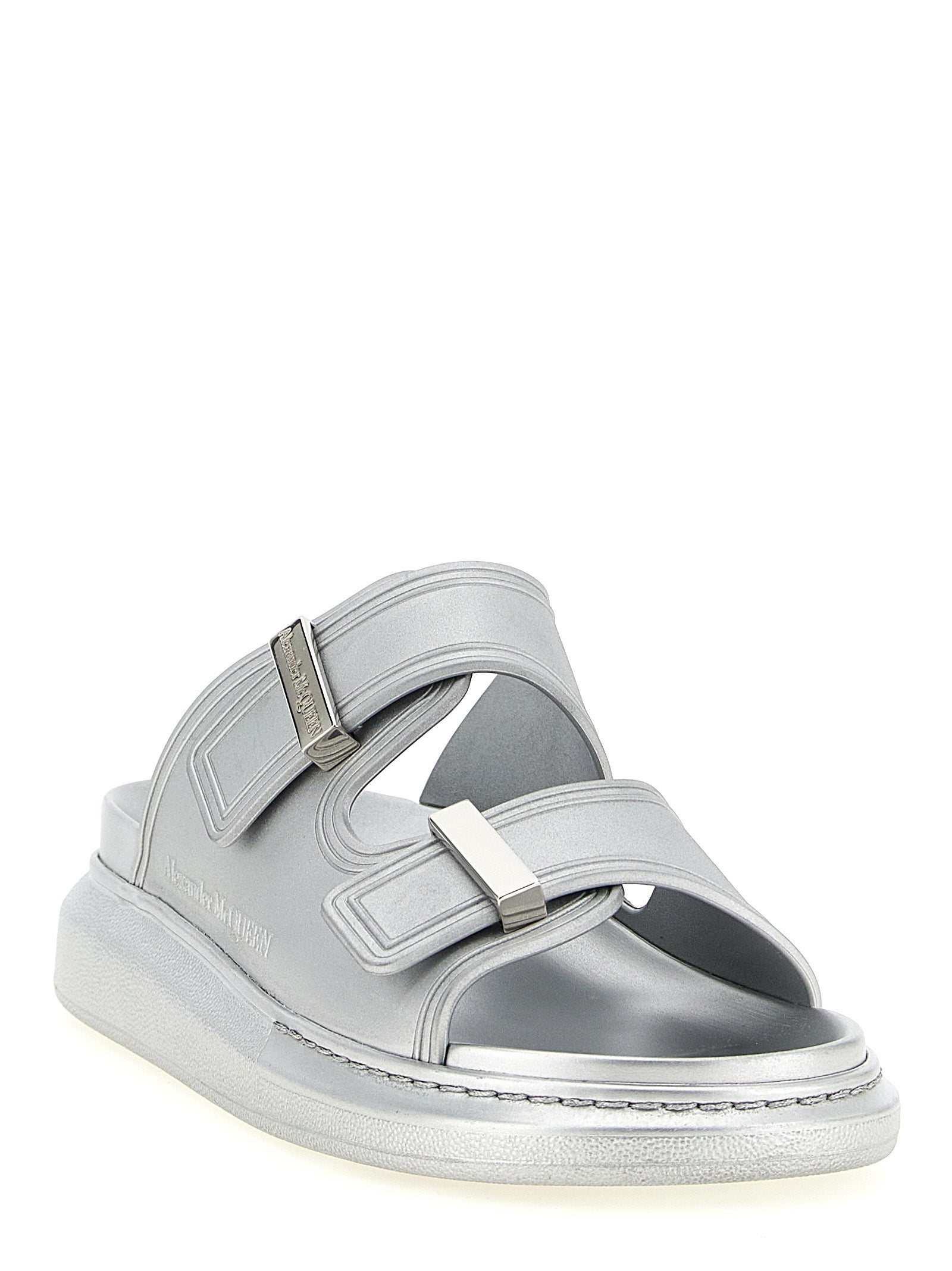 Experience the allure of Alexander McQueen's Silver Rubber Slides, where avant-garde design meets luxurious comfort, perfect for those who embody sophistication and style.