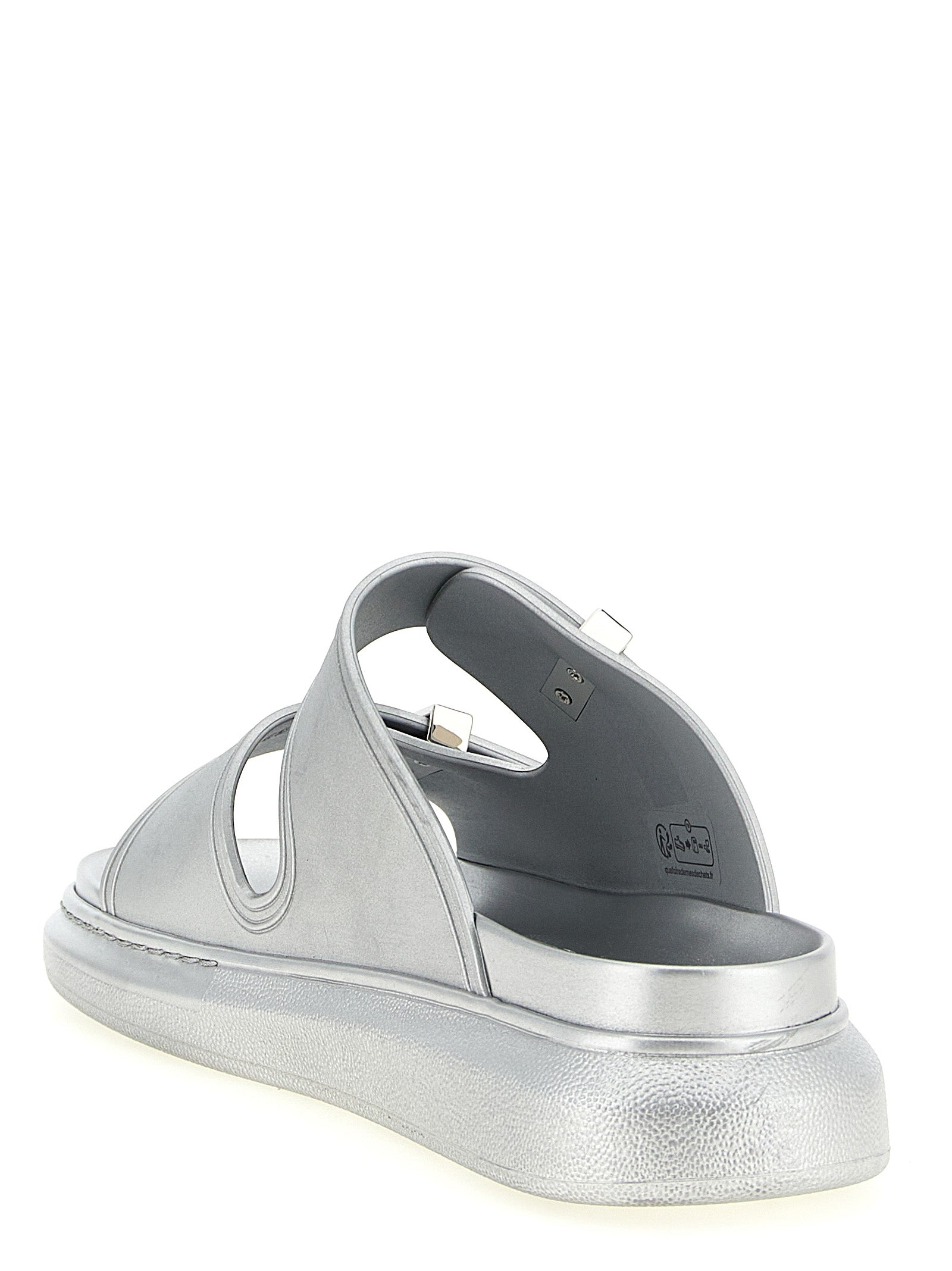 Experience the allure of Alexander McQueen Silver Rubber Slides, where avant-garde design meets luxurious comfort, perfect for the modern connoisseur.