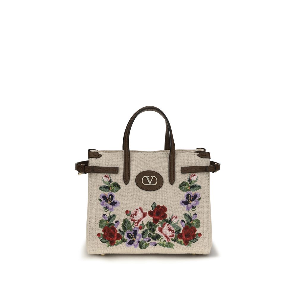 Discover the Valentino Garavani Beige Linen Shoulder Bag, a masterpiece of embroidered luxury from the AW26 collection, embodying sophistication and timeless elegance.