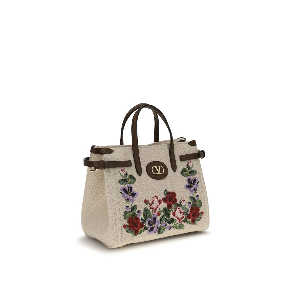 Discover the Valentino Garavani Beige Linen Shoulder Bag, a masterpiece of embroidered linen and floral elegance, embodying timeless luxury for the discerning individual.