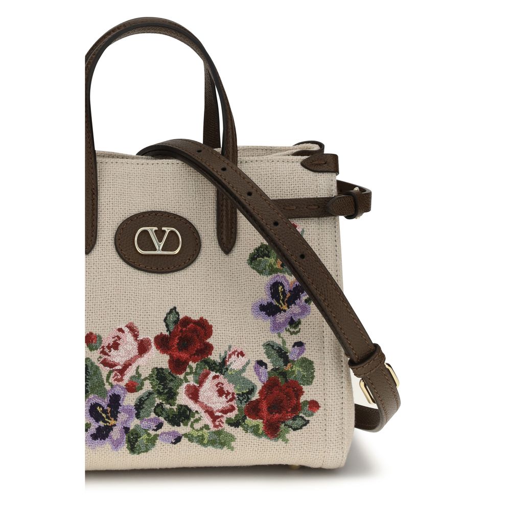 Indulge in the exquisite Valentino Garavani Beige Linen Shoulder Bag, a masterpiece of embroidered linen and floral elegance, perfect for elevating any sophisticated ensemble.