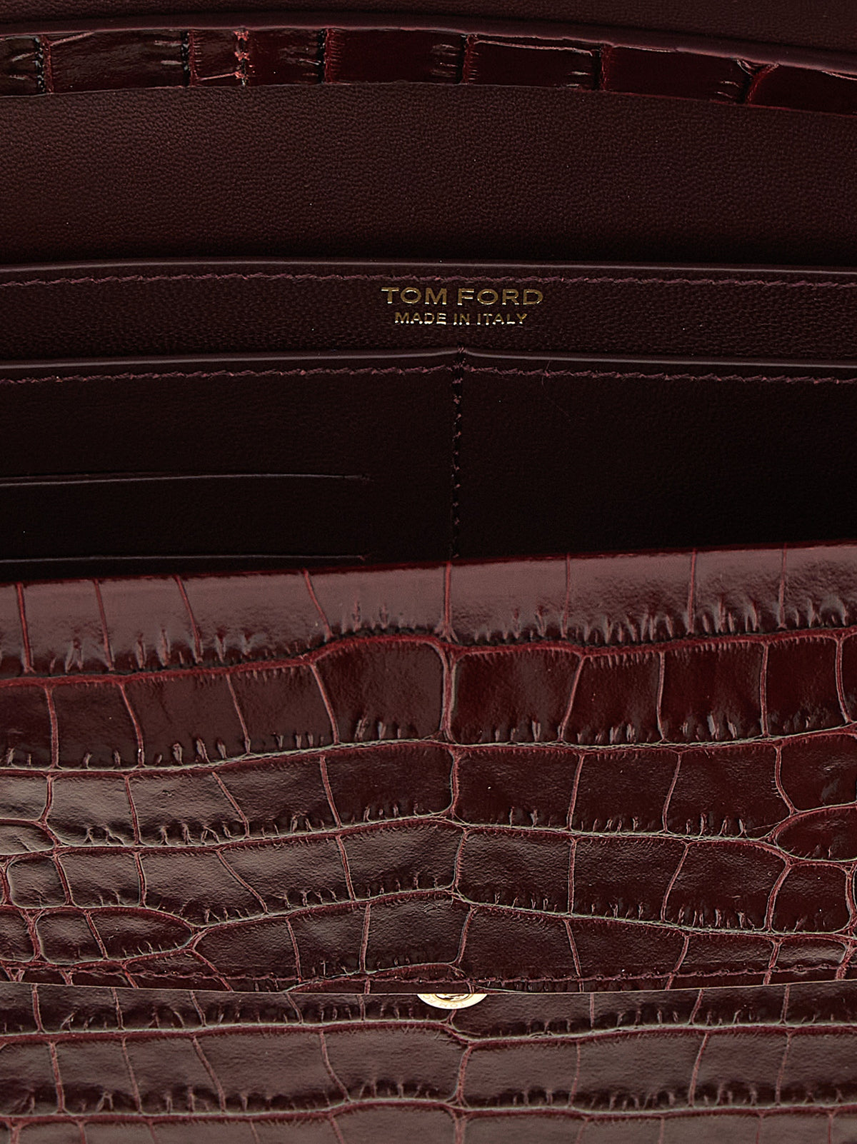 Indulge in the exquisite Tom Ford Bordeaux Calfskin Clutch Bag, a masterpiece of Italian craftsmanship that redefines elegance and sophistication for the discerning individual.