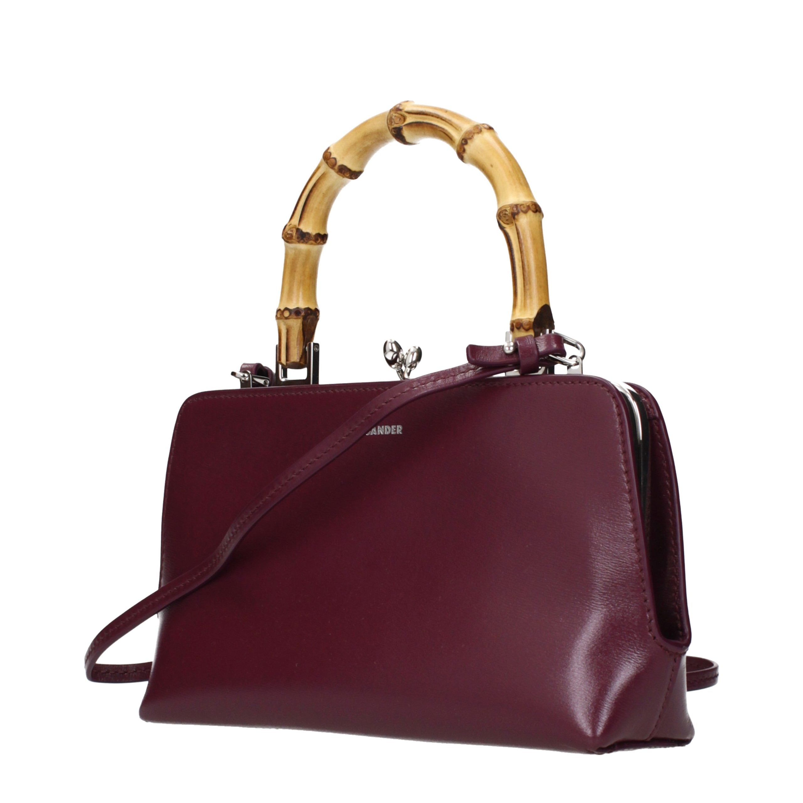 Experience the allure of the Jil Sander Red Leather Handbag, a masterpiece of structured elegance that embodies luxury and sophistication for every occasion.