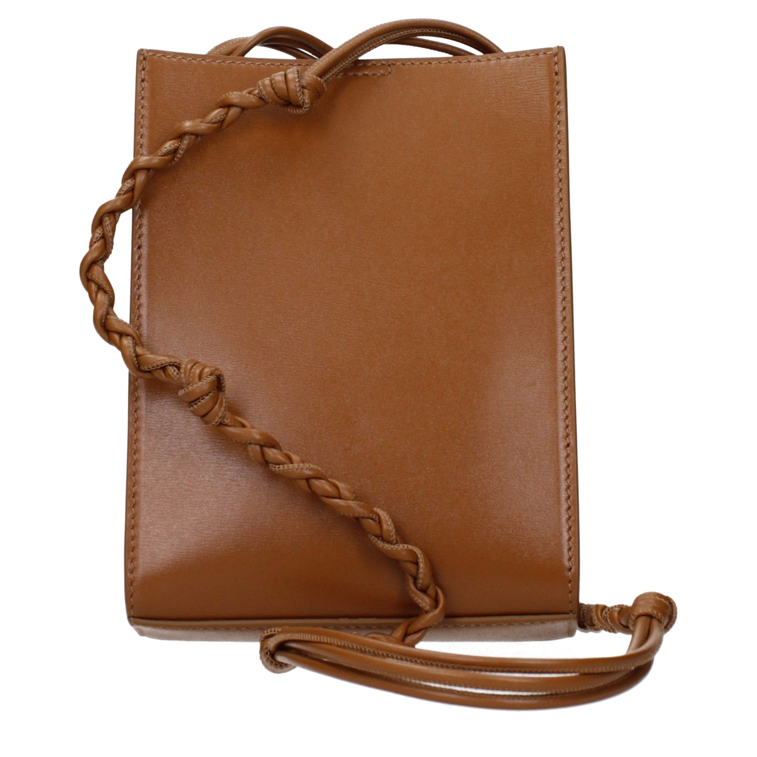 Indulge in the exquisite allure of the Jil Sander Brown Leather Crossbody Bag, a symbol of refined elegance and timeless sophistication for the discerning individual.