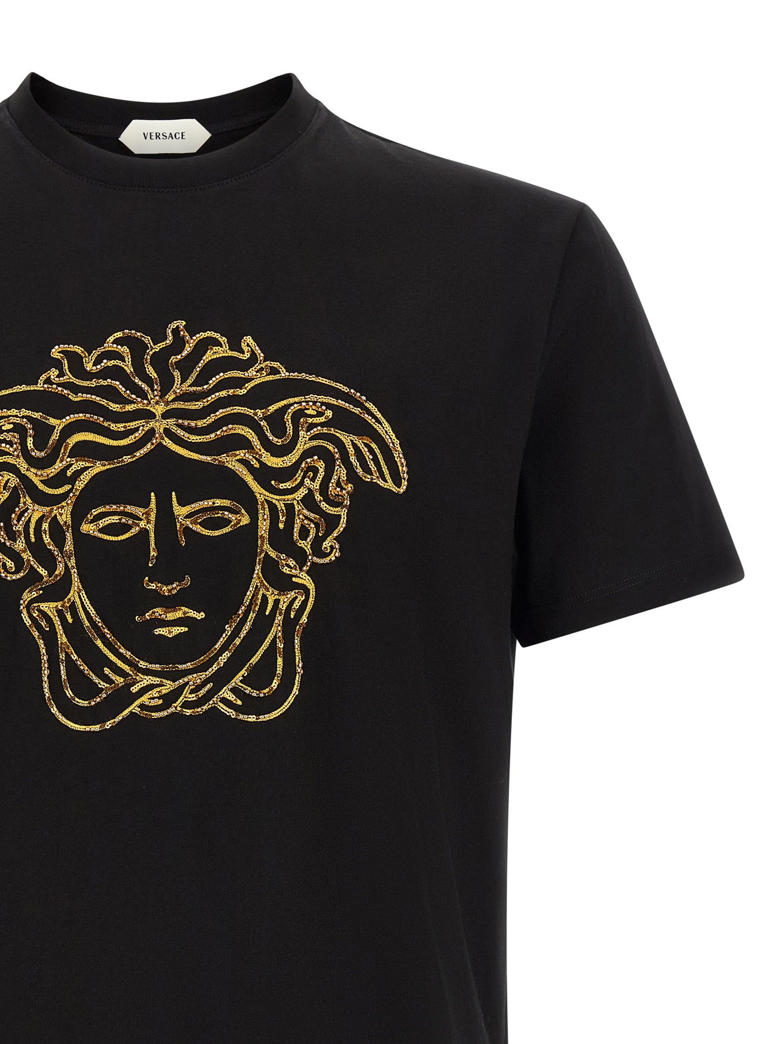 Indulge in the exquisite allure of Versace's Black Cotton T-Shirt, featuring iconic gold Medusa embroidery, a testament to refined craftsmanship and timeless elegance.