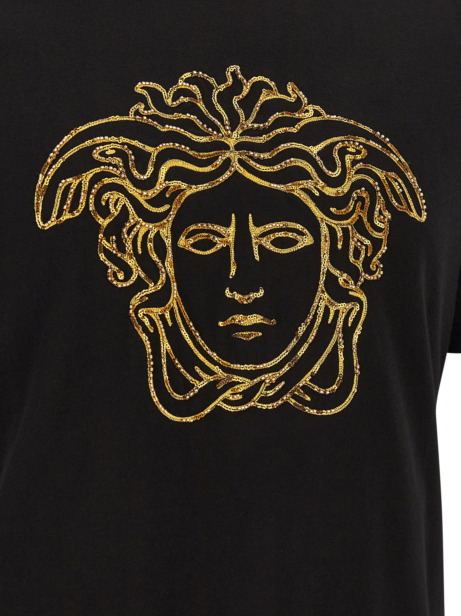Discover the Versace Black Cotton T-Shirt, a masterpiece of Italian craftsmanship adorned with a striking gold Medusa embroidery, elevating your style to new heights.