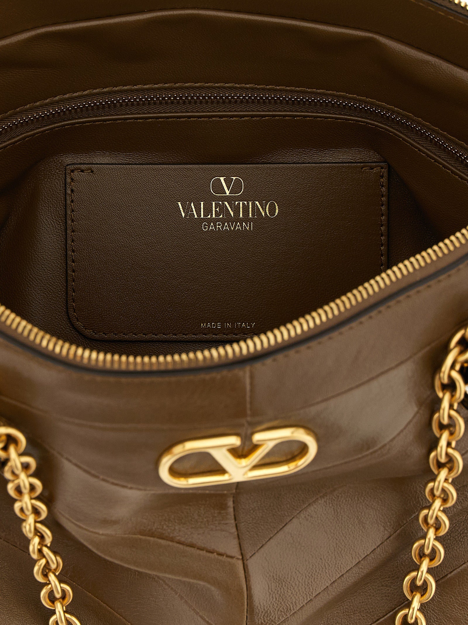 Elevate your style with the Valentino Garavani Brown Lamb Leather Shoulder Bag, a masterpiece of Italian craftsmanship that embodies timeless sophistication and allure.