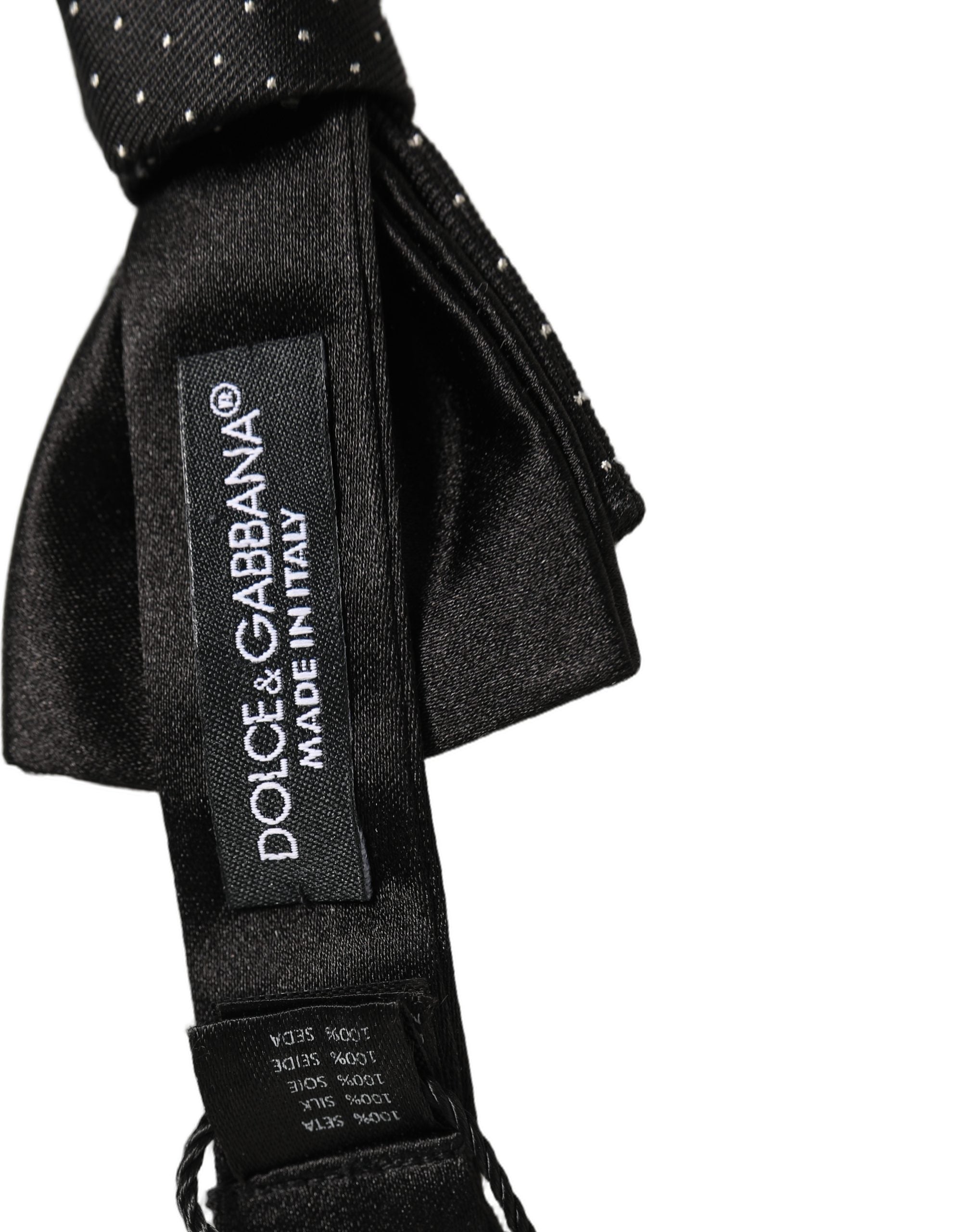 Experience the allure of Dolce & Gabbana's Black DG Polka Dot Bow Tie, a masterpiece of silk craftsmanship that elevates any ensemble with timeless sophistication.