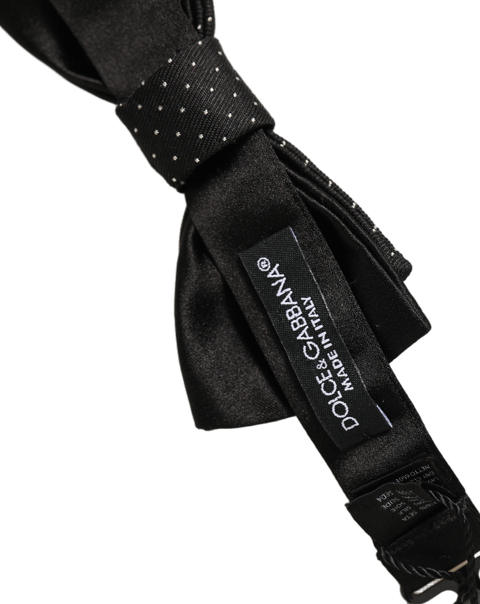 Indulge in the exquisite craftsmanship of Dolce & Gabbana's Black DG Polka Dot Bow Tie, a luxurious silk accessory that elevates any ensemble with timeless sophistication.