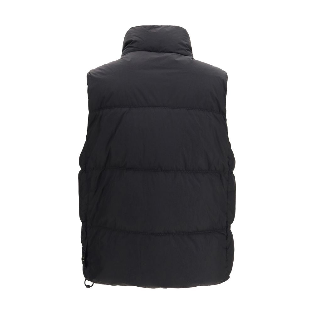 Discover the Stone Island Black Goose Down Sleeveless Jacket, a blend of technical mastery and sophisticated elegance crafted from recycled nylon for the discerning individual.