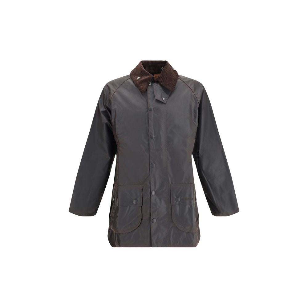 Experience the allure of the Barbour Black Cotton Coat, crafted from luxurious Thornproof waxed cotton, merging timeless elegance with unparalleled functionality for the discerning individual.