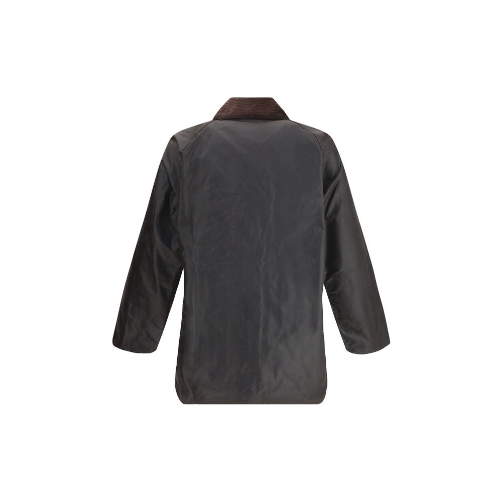 Elevate your wardrobe with the Barbour Black Cotton Coat, a masterpiece of Thornproof waxed cotton that seamlessly blends timeless elegance with modern functionality.