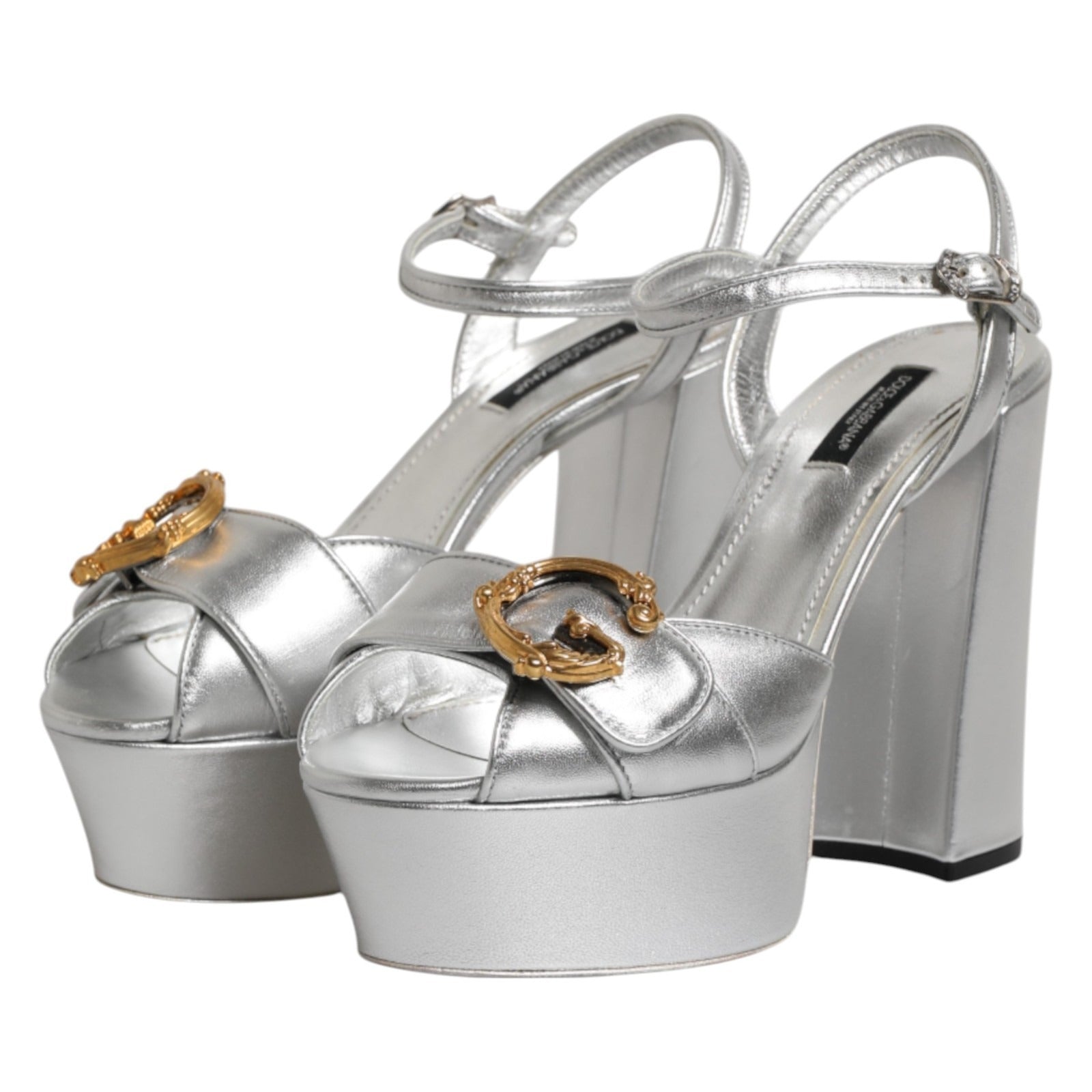 Step into opulence with Dolce & Gabbana Silver Logo Ankle Strap Heels, crafted from premium leather in Italy, embodying elegance and sophistication for every occasion.
