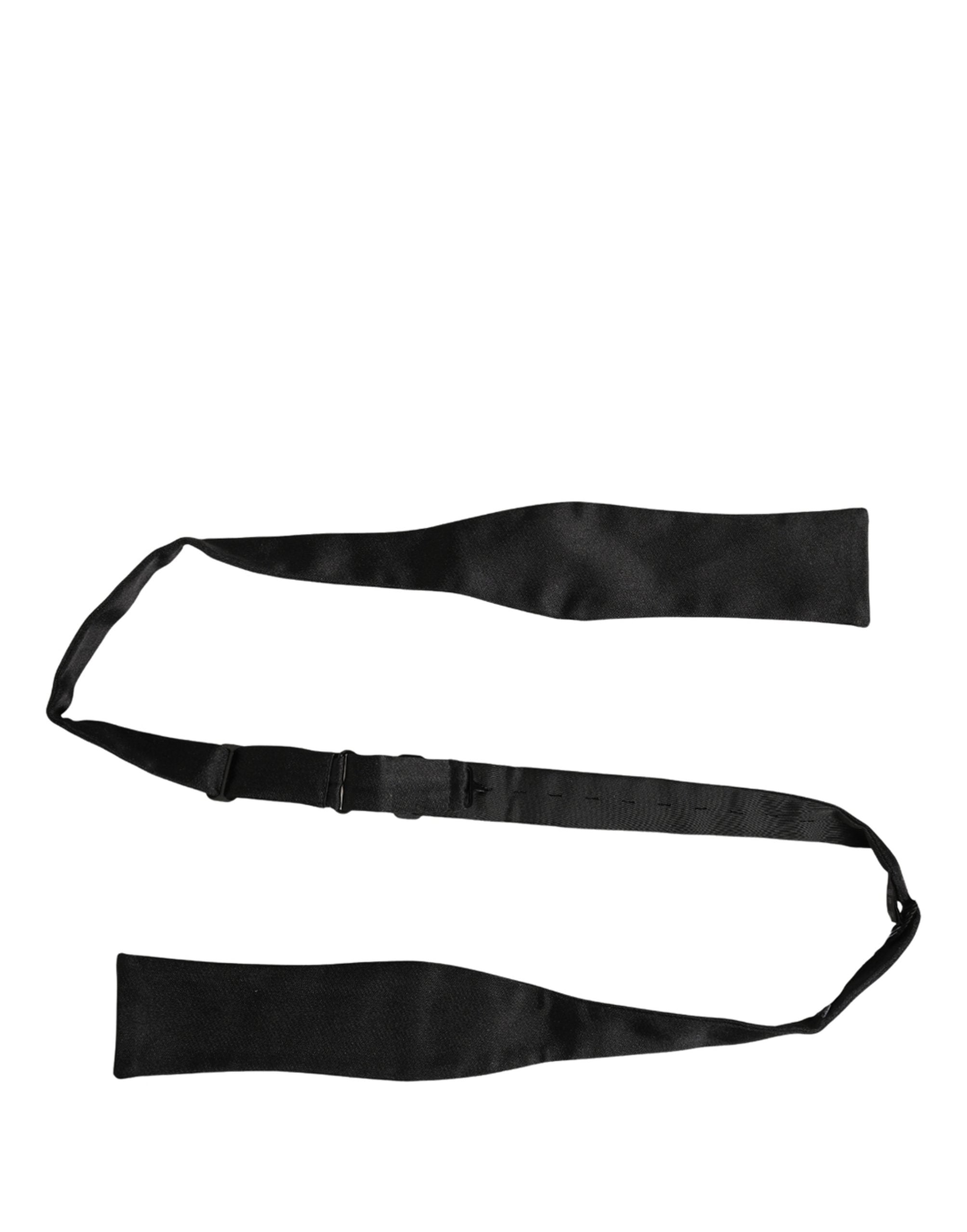 Elevate your elegance with the Dolce & Gabbana black silk bow tie, a timeless accessory that embodies luxury and sophistication for every discerning individual.