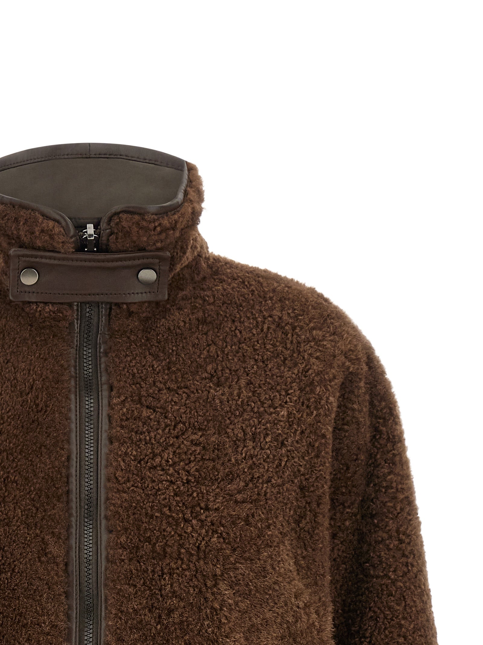 Indulge in the Brunello Cucinelli Brown Lamb Leather Biker Jacket, a reversible masterpiece of pure ‘Fuzzy’ lamb shearling, embodying elegance and sophistication for the discerning individual.
