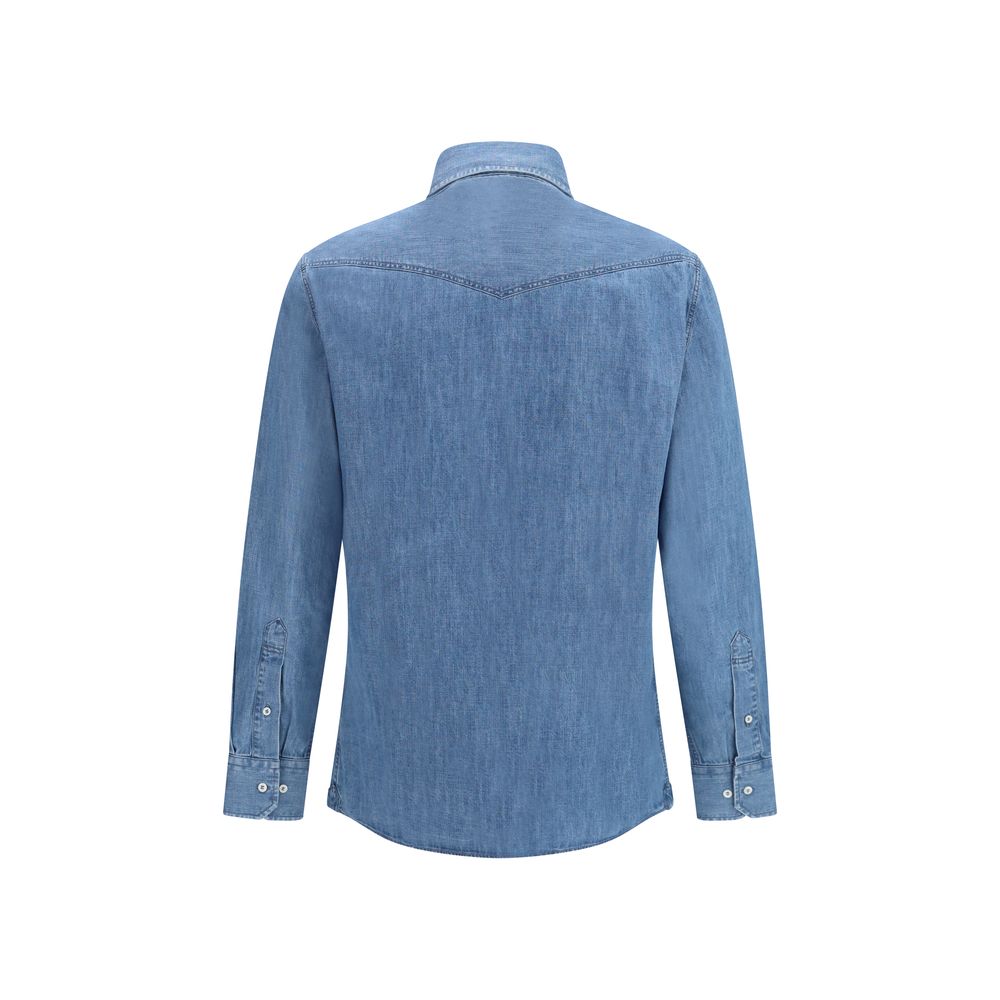 Discover the Brunello Cucinelli Blue Denim Shirt, a masterpiece of effortless elegance crafted from 100% cotton, perfect for the discerning individual seeking timeless style.