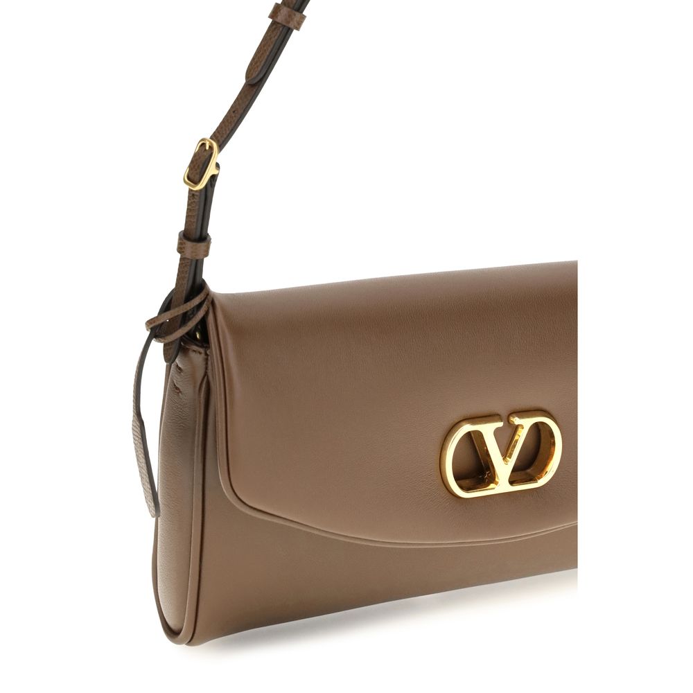 Indulge in the elegance of the Valentino Garavani Brown Calf Leather Bos Taurus Shoulder Bag, a masterpiece of refined craftsmanship and timeless luxury.
