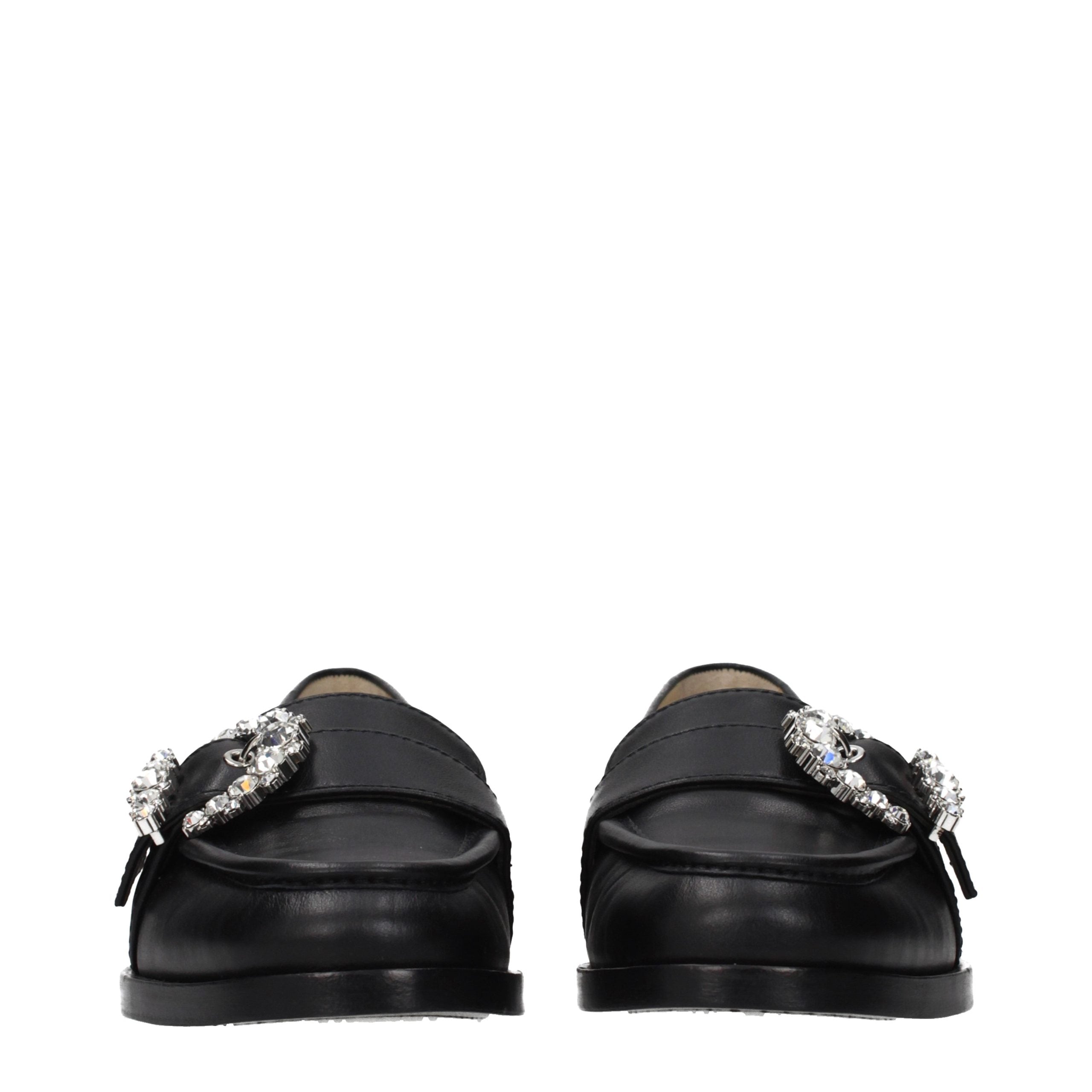 Indulge in the elegance of Jimmy Choo Black Leather Slip-On Loafers, where exquisite craftsmanship meets timeless luxury, perfect for the discerning individual.