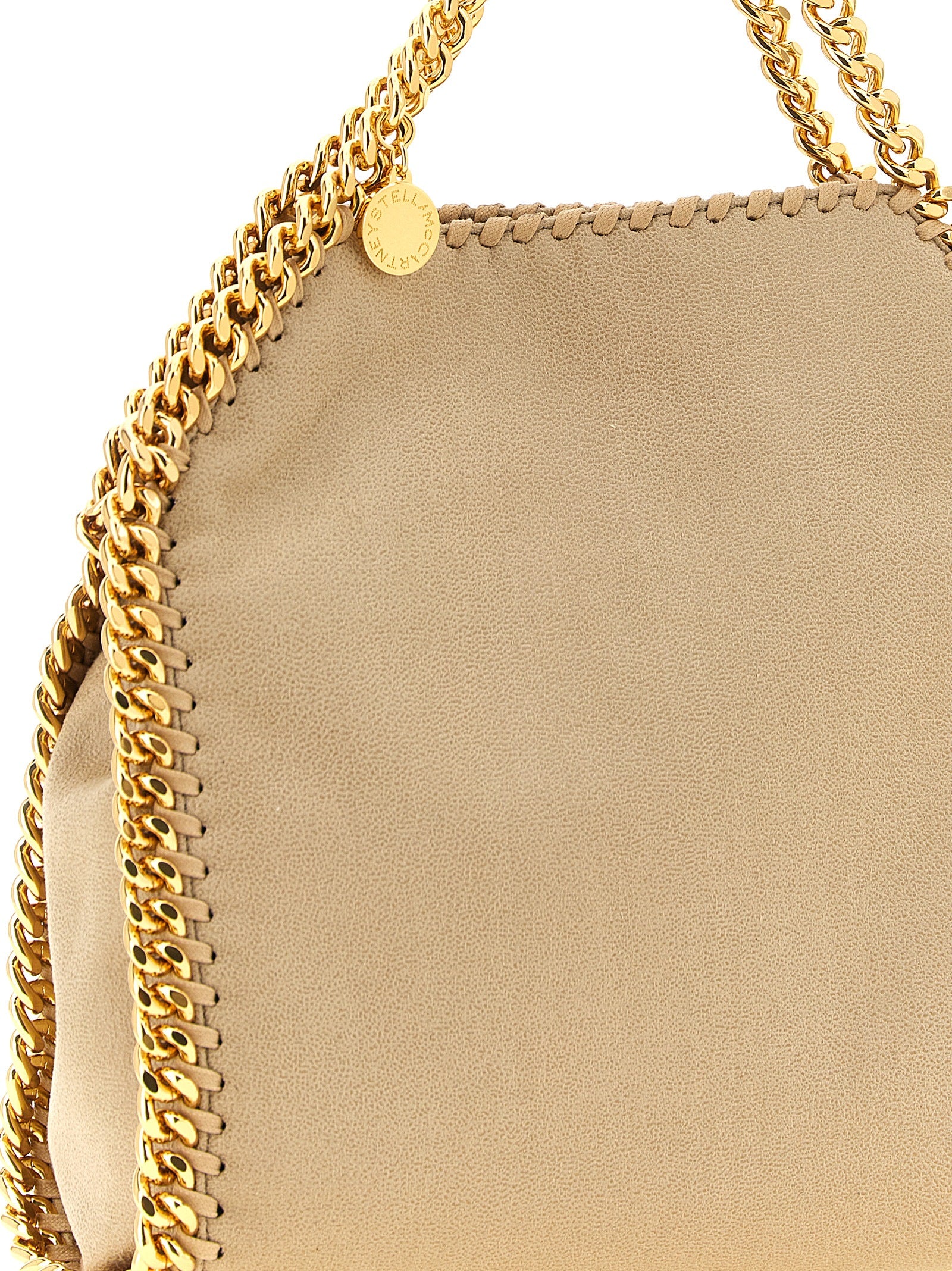 Discover the Stella McCartney Falabella Mini, a beige polyester shoulder bag that embodies sustainable luxury with its signature chain trim, perfect for the modern connoisseur.