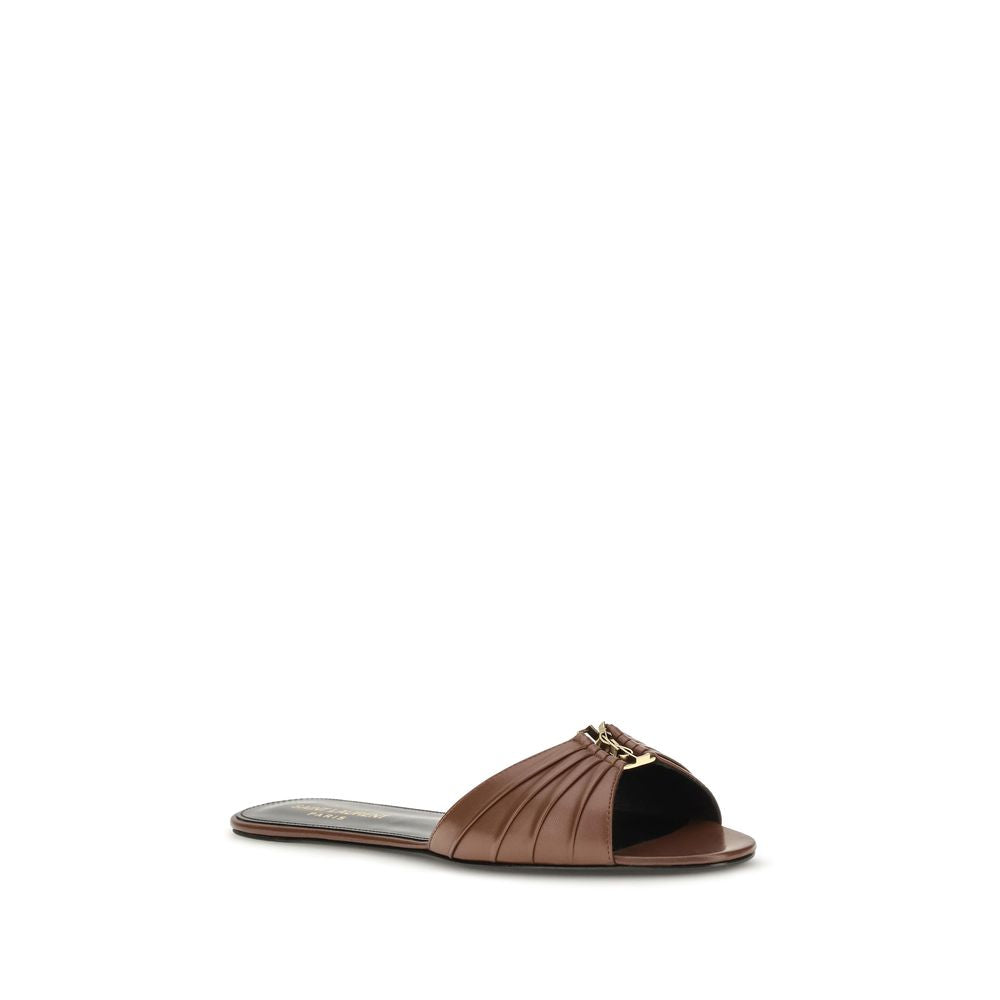 Step into a world of luxury with Saint Laurent's Brown Calf Leather Bos Taurus Mules, crafted from exquisite metal-free tanned leather, embodying timeless elegance and sophistication.