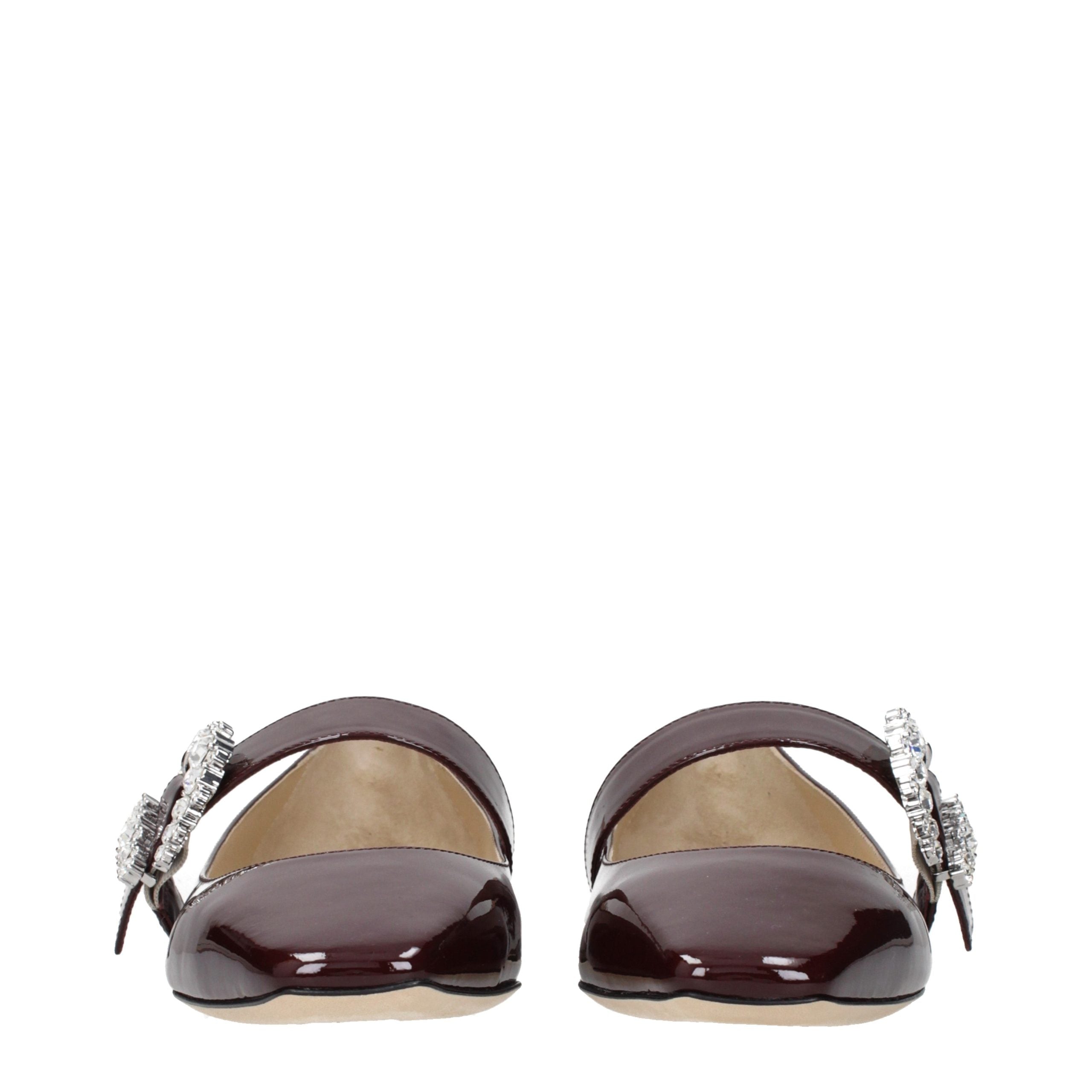 Indulge in the timeless elegance of Jimmy Choo Red Leather Ballet Flats, where luxurious patent leather meets exquisite rhinestone detailing, perfect for any refined wardrobe.