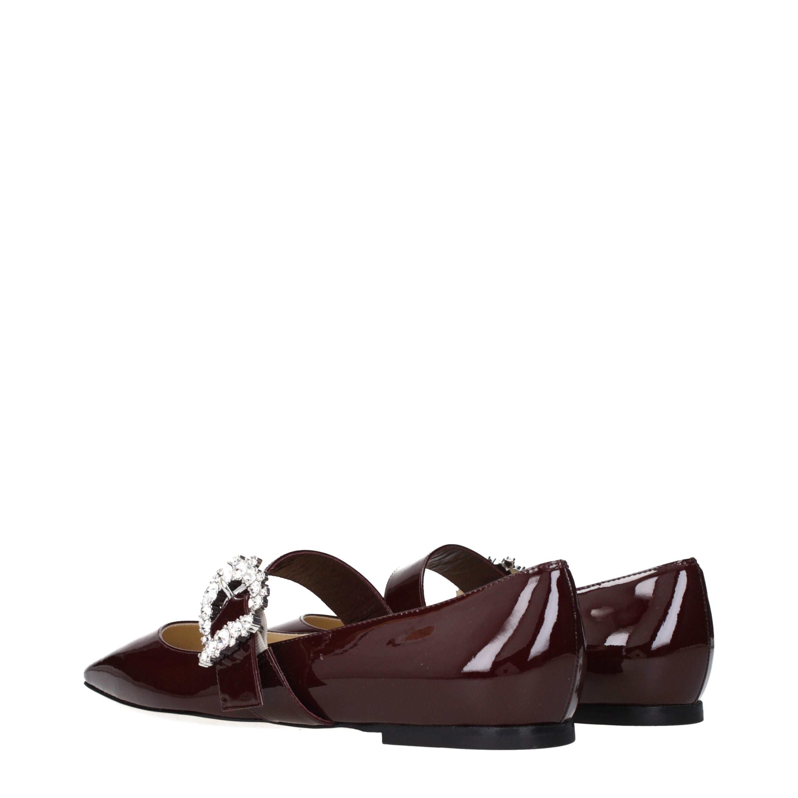 Indulge in the allure of Jimmy Choo Red Leather Ballet Flats, exquisitely crafted in patent leather, embodying timeless elegance and sophisticated charm for every occasion.