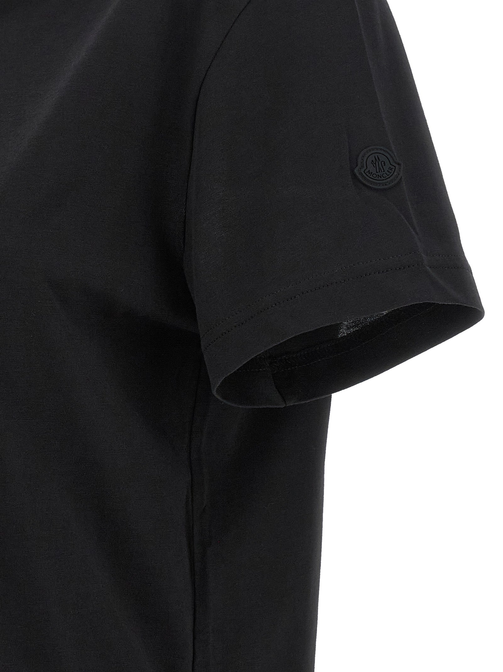 Experience the allure of Moncler's Black Cotton T-Shirt, a masterpiece of bold minimalism crafted from pure cotton, embodying luxury and effortless sophistication for the discerning individual.