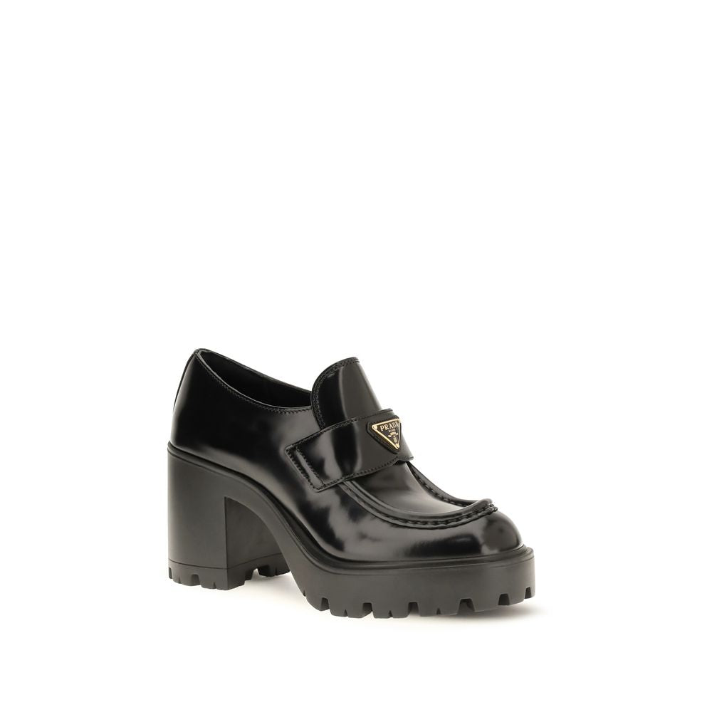 Indulge in the exquisite Prada Black Calf Leather Bos Taurus Platform Loafers, where luxurious craftsmanship meets modern elegance, elevating your style with every step.