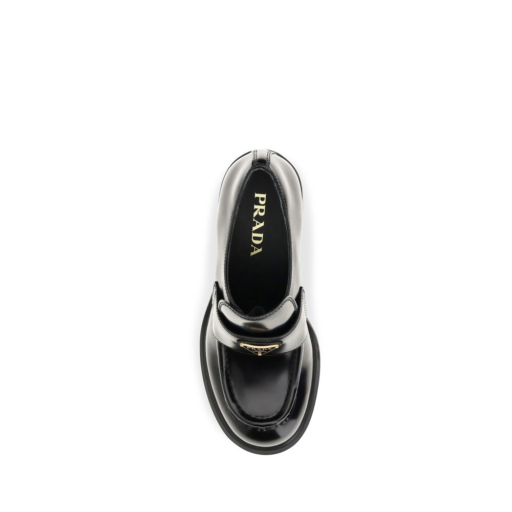 Indulge in the Prada Black Calf Leather Bos Taurus Platform Loafers, where exquisite craftsmanship meets modern elegance, elevating your style to new heights.