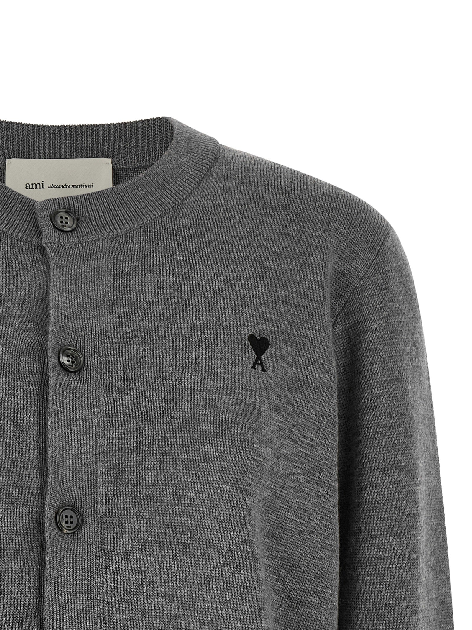 Discover the Ami Paris Gray Wool Cardigan, a masterpiece of 100% wool craftsmanship, merging timeless elegance with a luxurious silhouette for the discerning wardrobe.