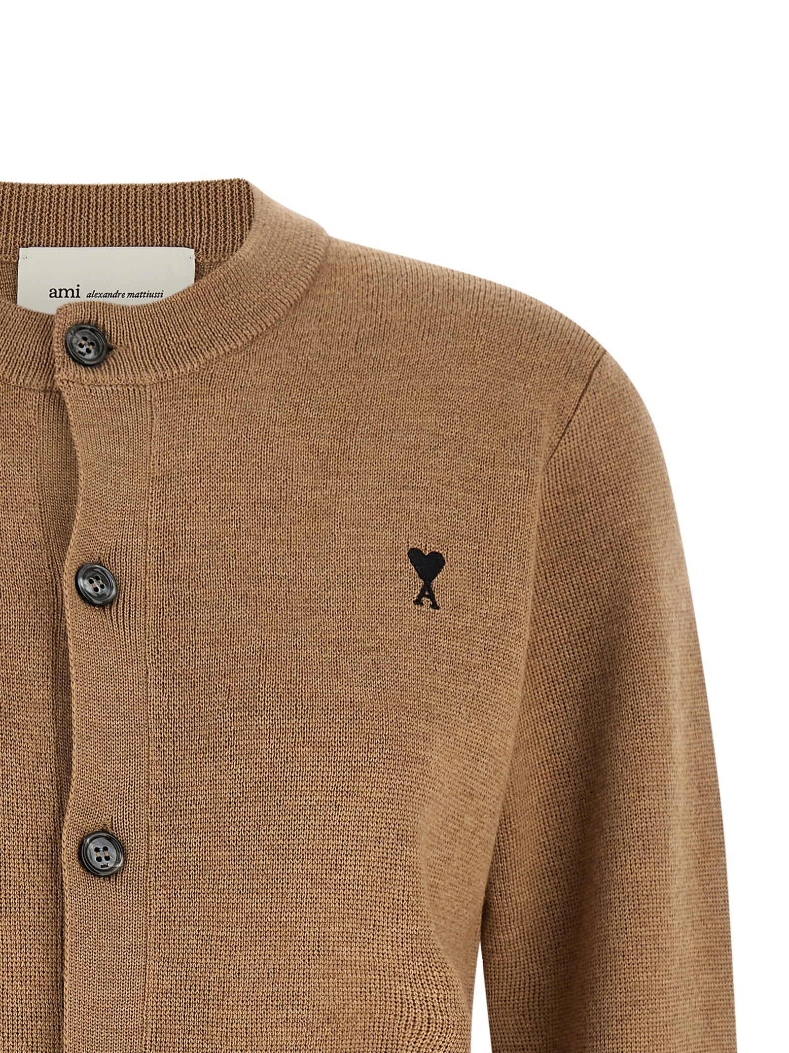 Indulge in the Ami Paris Beige Wool Cardigan, a masterpiece of 100% wool craftsmanship that elevates your wardrobe with timeless elegance and Parisian allure.