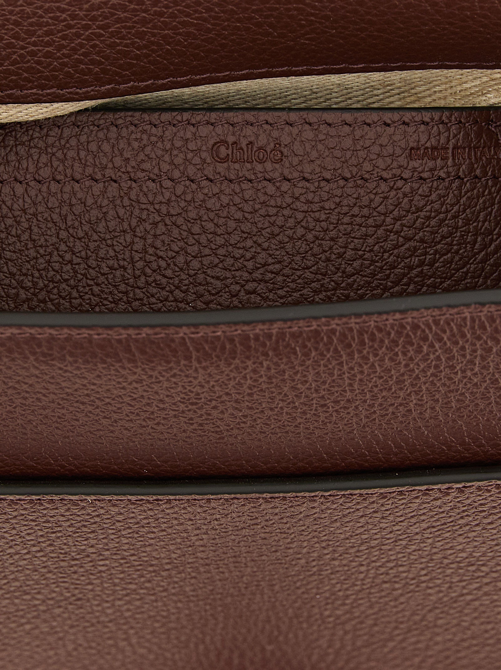 Indulge in the Chloé Brown Calfskin Crossbody Bag, a masterpiece of artisan craftsmanship and luxurious garnet calfskin, embodying sophistication for the discerning individual.