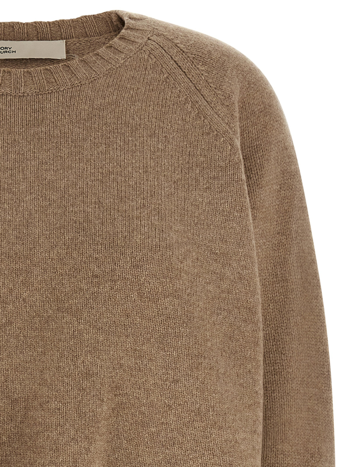 Experience the allure of the Tory Burch Beige Wool Cardigan, a masterpiece of pure wool craftsmanship, designed for timeless elegance and effortless sophistication.
