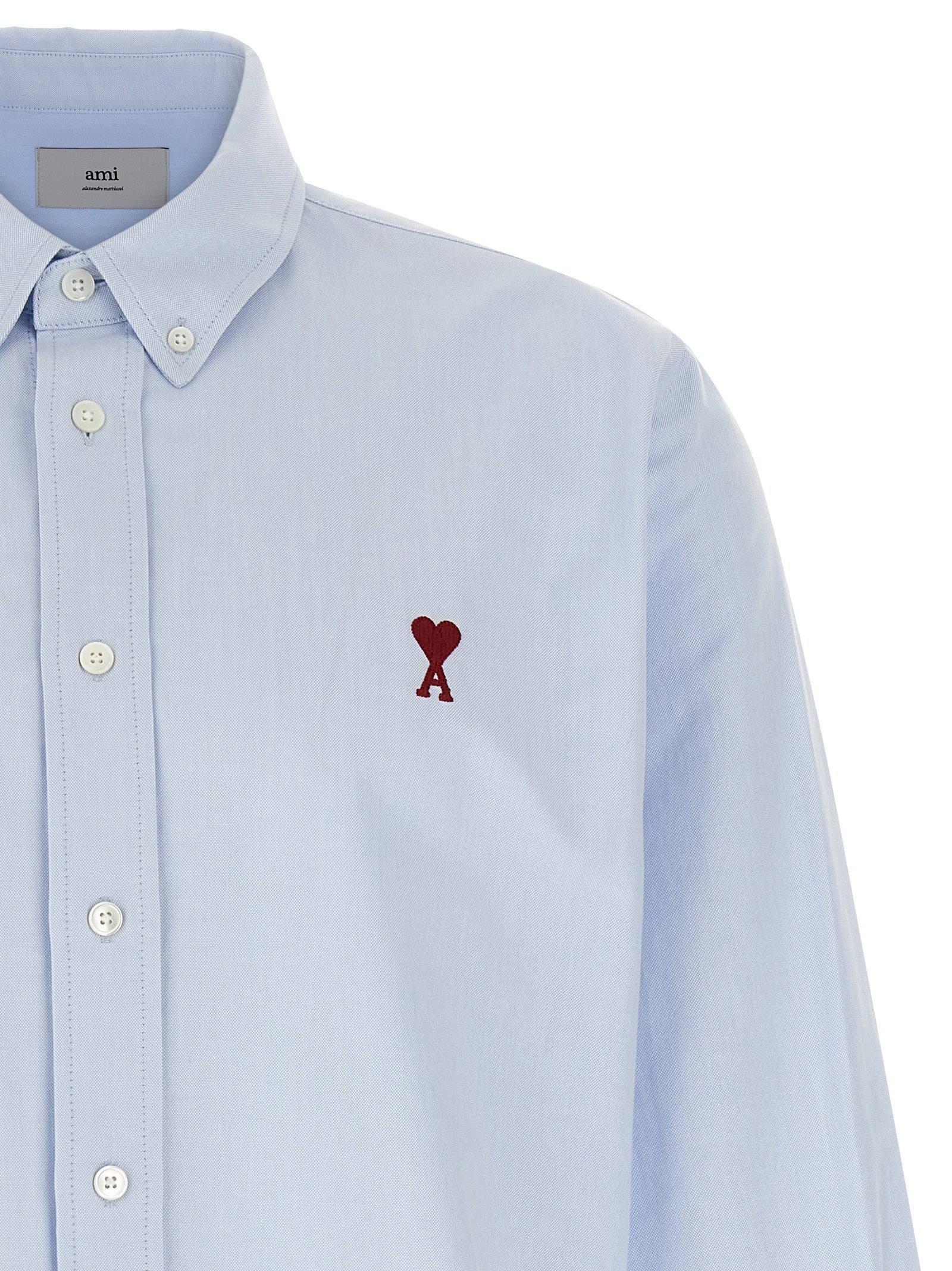 Elevate your style with the Ami Paris Blue Cotton Blouse, a masterpiece of French elegance featuring iconic embroidery, perfect for those who appreciate luxury and sophistication.