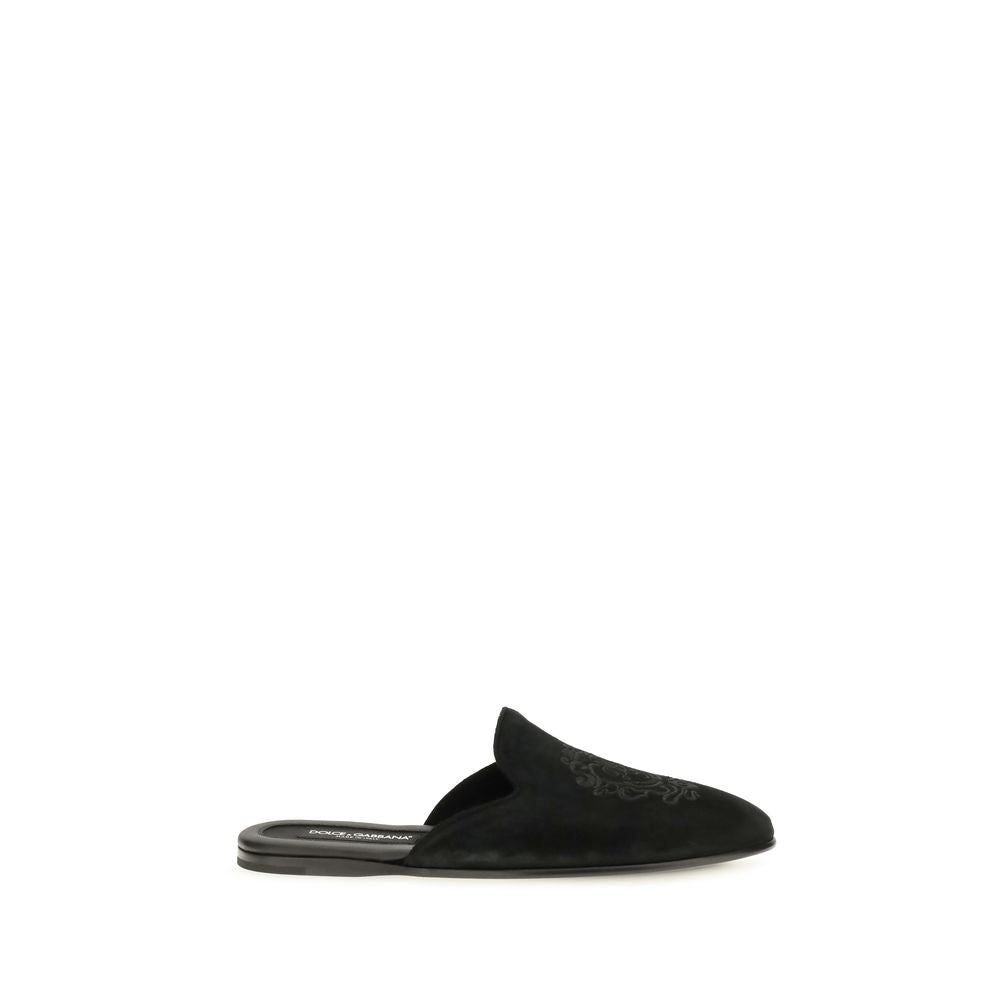 Experience the sublime elegance of Dolce & Gabbana's Black Calf Leather Bos Taurus Mules, where exquisite craftsmanship meets luxurious comfort for the discerning individual.