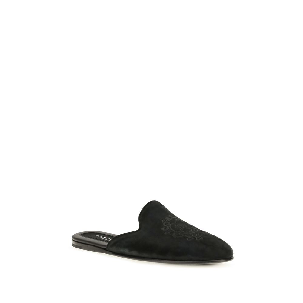 Discover the Dolce & Gabbana Black Calf Leather Bos Taurus Mules, where exquisite craftsmanship meets timeless elegance, perfect for the discerning individual.