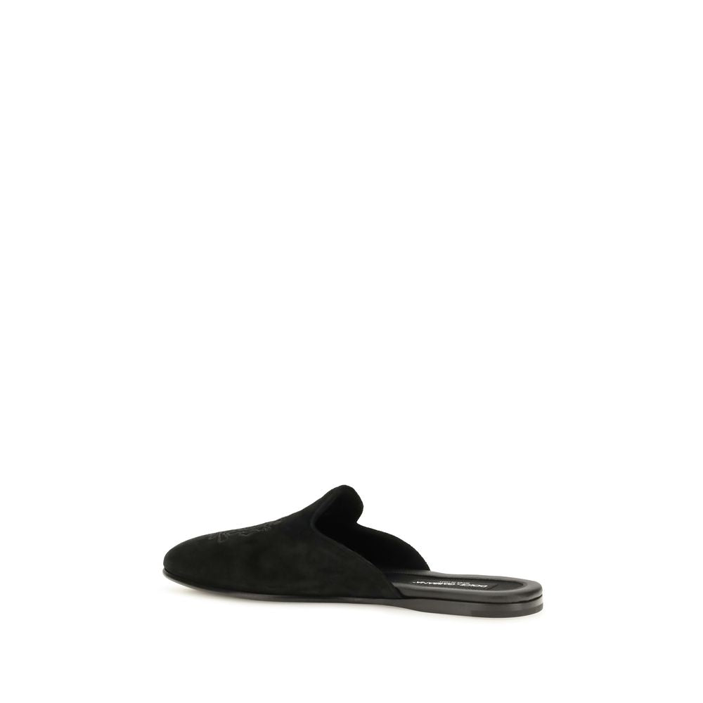 Elevate your style with Dolce & Gabbana Black Calf Leather Bos Taurus Mules, where exquisite craftsmanship meets timeless elegance for the discerning individual.