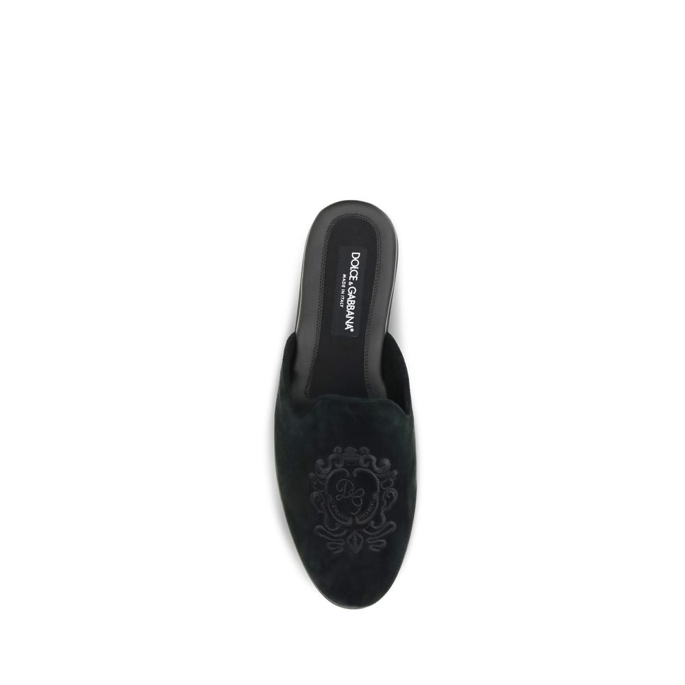 Experience the allure of Dolce & Gabbana's Black Calf Leather Bos Taurus Mules, where exquisite craftsmanship meets timeless elegance for the discerning individual.
