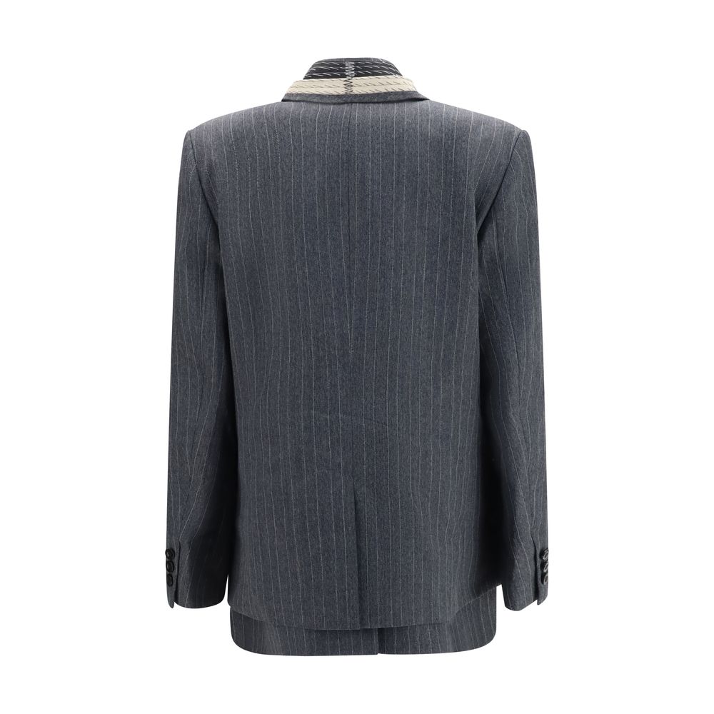 Elevate your wardrobe with the Sacai Gray Wool Oves Aries Jacket, a masterpiece of 100% wool craftsmanship that embodies sophistication and modern luxury for the discerning individual.