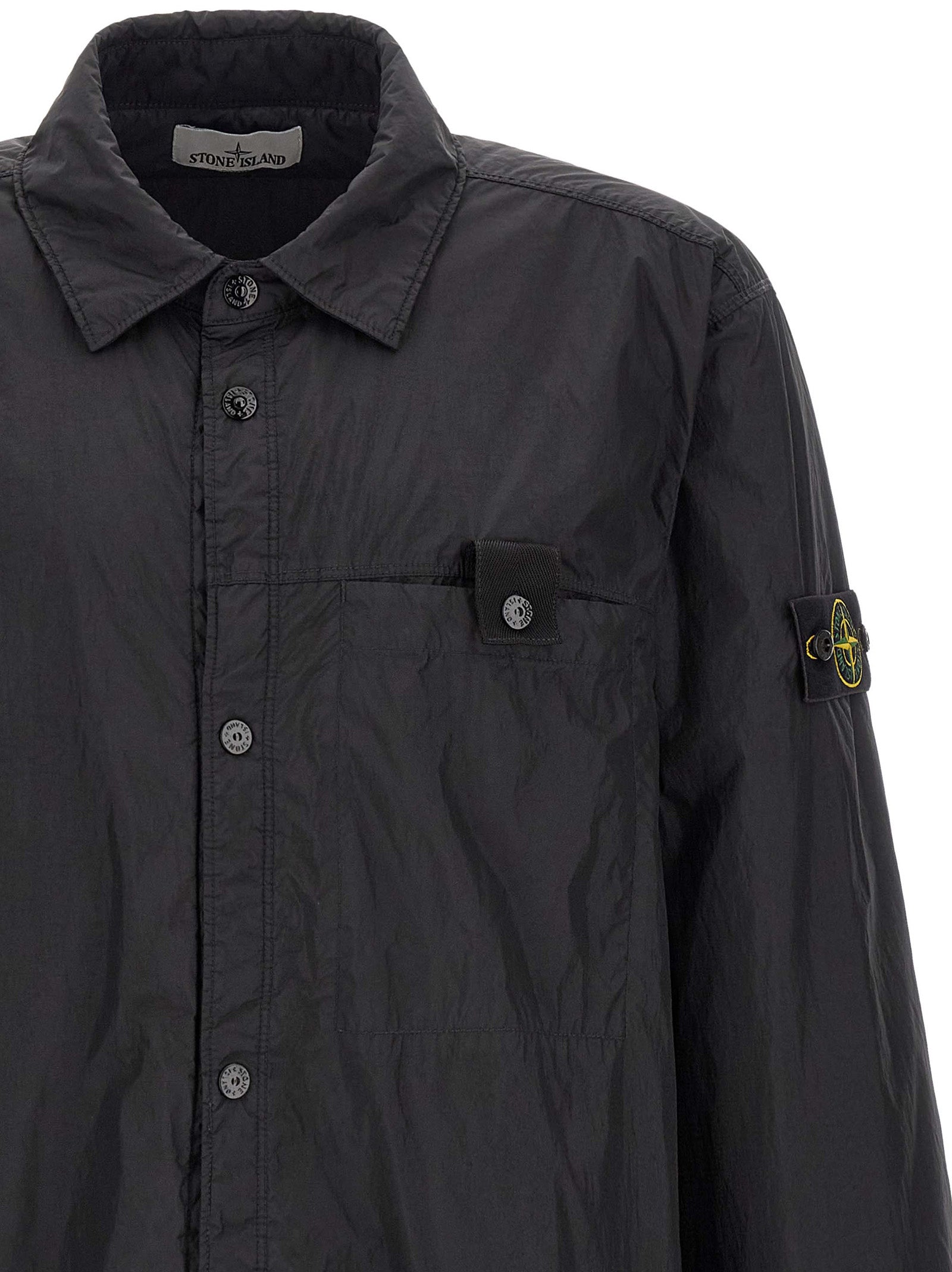 Elevate your wardrobe with the Stone Island Black Polyamide Shell Jacket, a masterful blend of craftsmanship and sustainable luxury, designed for the discerning individual.