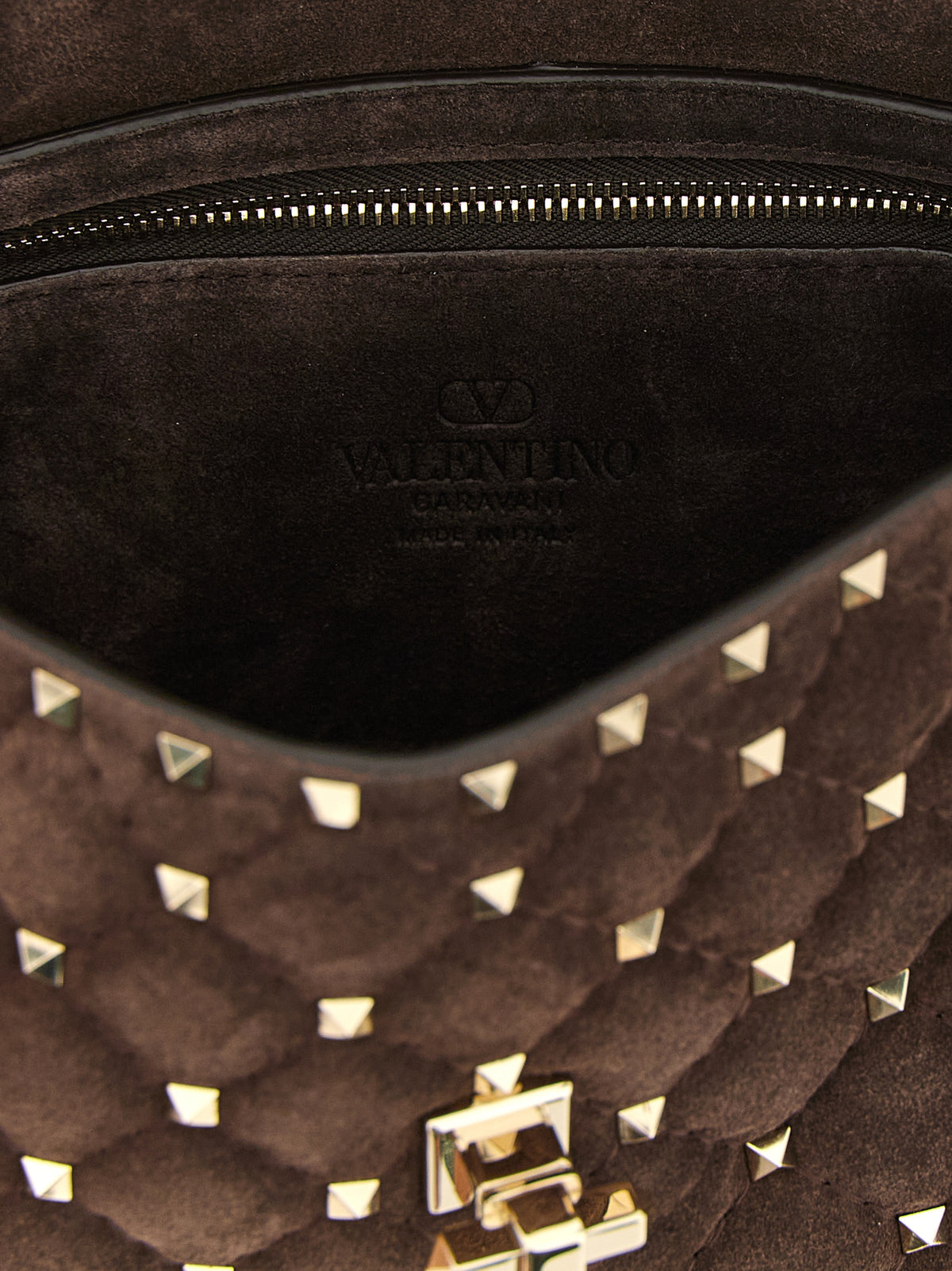 Experience the allure of the Valentino Garavani Brown Calfskin Crossbody Bag, a masterpiece of exquisite craftsmanship and timeless elegance, perfect for the discerning fashion lover.